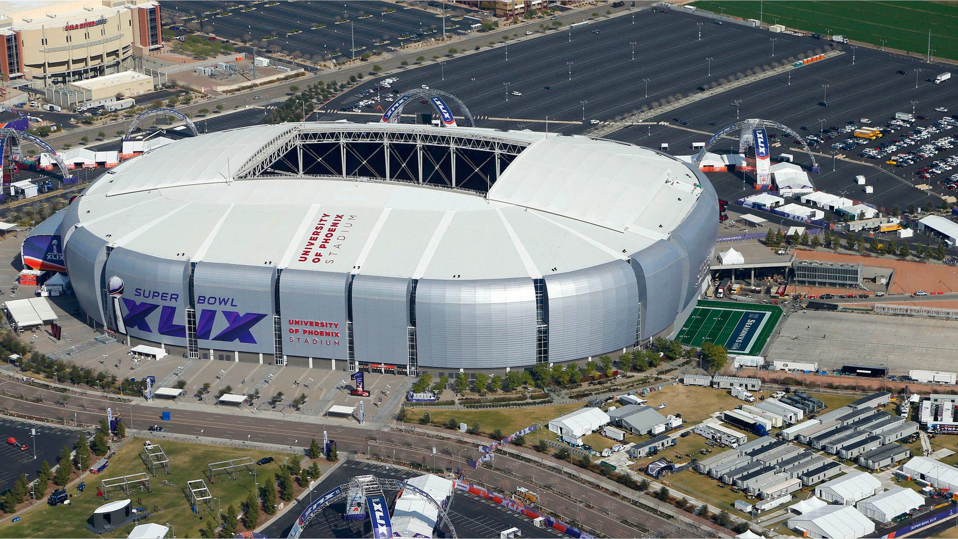 Jan. 28, 2015: In this aerial photo, the playing field for the NFL Super Bowl XLIX football game is rolled into the University of Phoenix Stadium.