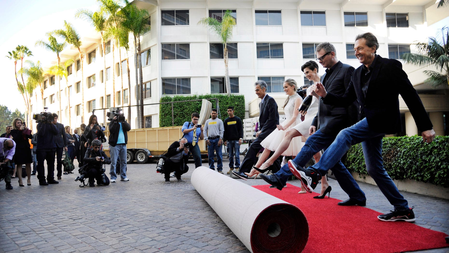 Jan. 8, 2015: Barry Adelman, far right, executive producer of the 72nd Annual Golden Globe Awards, is joined by, left to right, fellow Golden Globes executive producer Allen Shapiro, Miss Golden Globe 2015 Greer Grammer, Moet Ambassador Elettra Wiedemann and Hollywood Foreign Press Association President Theo Kingma as they roll out the red carpet at the 72nd Annual Golden Globe Awards Preview Day at the Beverly Hilton in Beverly Hills, Calif. (AP)