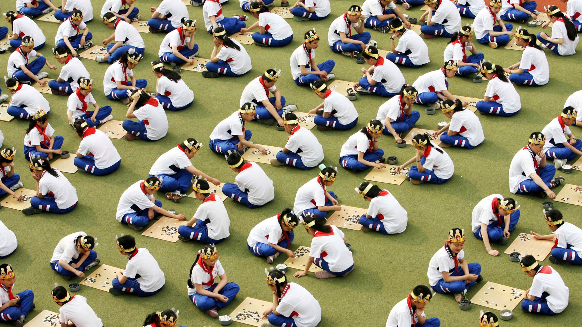 Students play the board game "Go", known as "Weiqi" in Chinese, during a competition to mark the 100-day countdown to the opening of Beijing Olympics at a primary school in Suzhou, Jiangsu province. (REUTERS/China Daily)