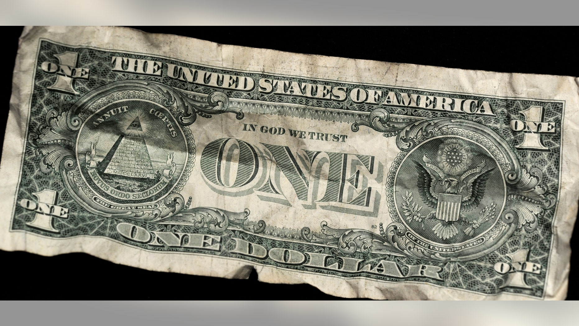 An old dollar note is pictured in Bammental, Germany, 19 April 2011. The rating agency Standard & Poor's (S&P) have questioned the future creditworthiness of the USA. They said that their evaluation of the financial strength would remain best note 'AAA', but they lowered their expectations for a long-term evaluation from 'stable' to 'negative'. Among the reasons named were the high budgetary deficits and a not very clear plan to minimise the raising national debt. Photo: Marius Becker