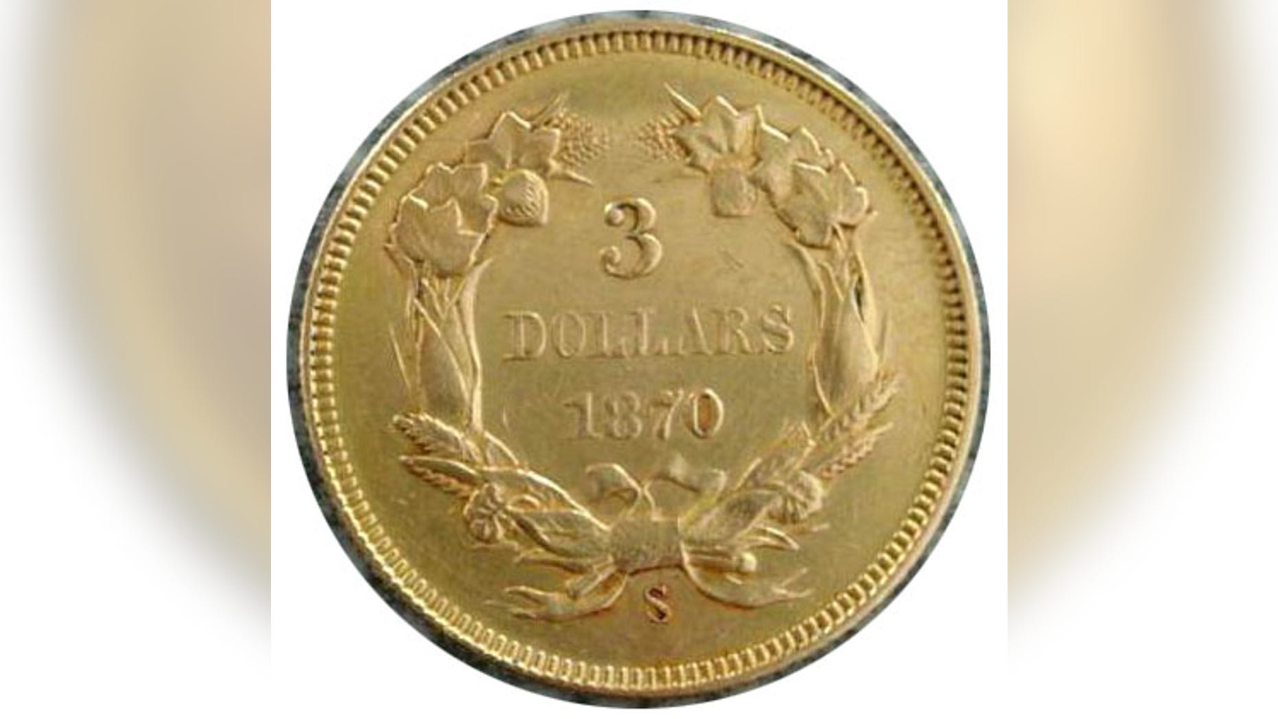 The coin, seen here, is believed to be a 1870-S $3 piece from the San Francisco Mint that was found embedded into a souvenir book, according to Steve White, owner of the Four Seasons Auction Gallery. (Courtesy: Four Seasons Auction Gallery)