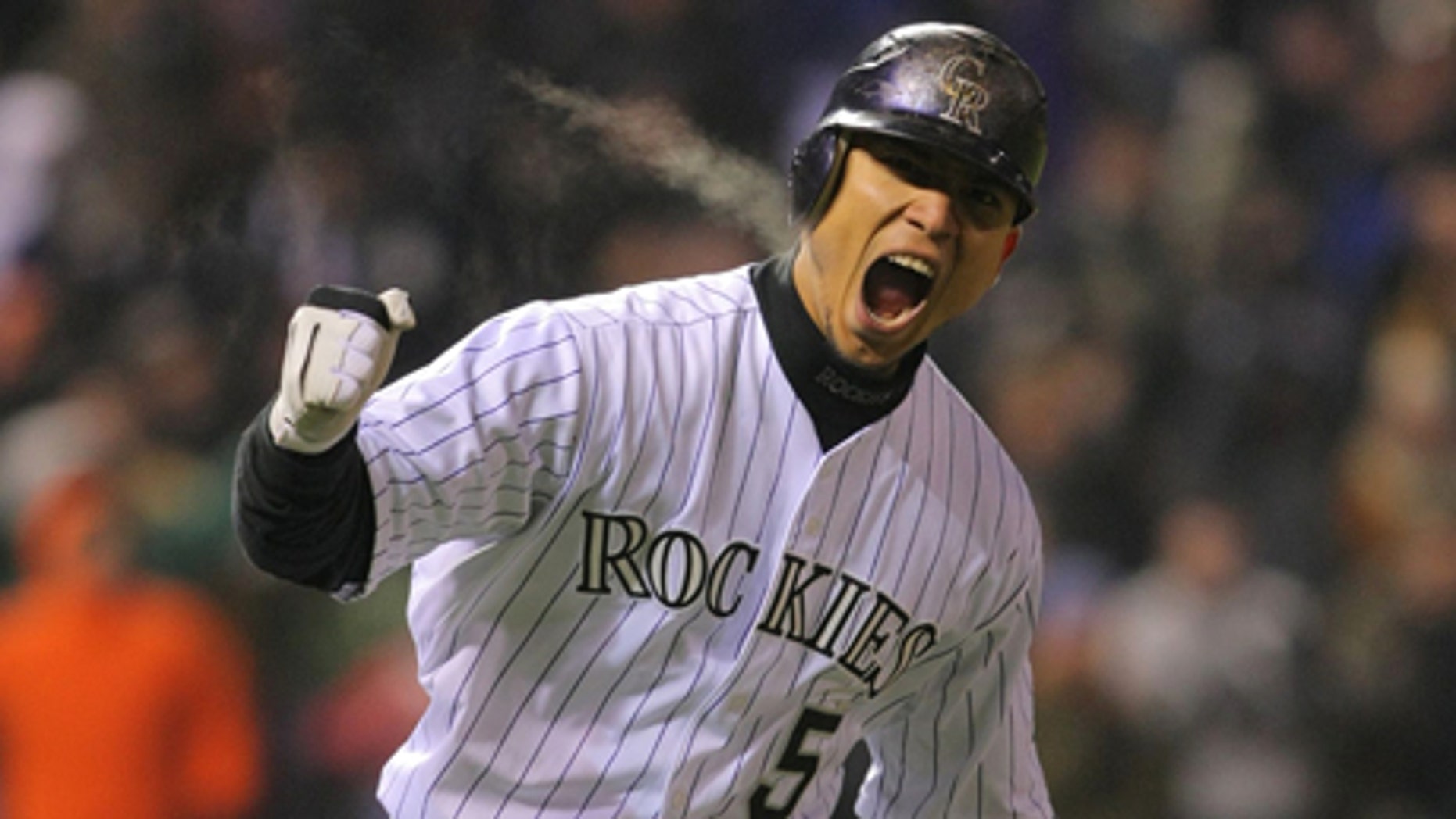 DENVER - OCTOBER 11: Carlos Gonzalez #5 of the Colorado Rockies reacts after hitting a home run in the bottom of the fourth inning against the Philadelphia Phillies in Game Three of the NLDS during the 2009 MLB Playoffs at Coors Field on October 11, 2009 in Denver, Colorado. (Photo by Doug Pensinger/ Getty Images)