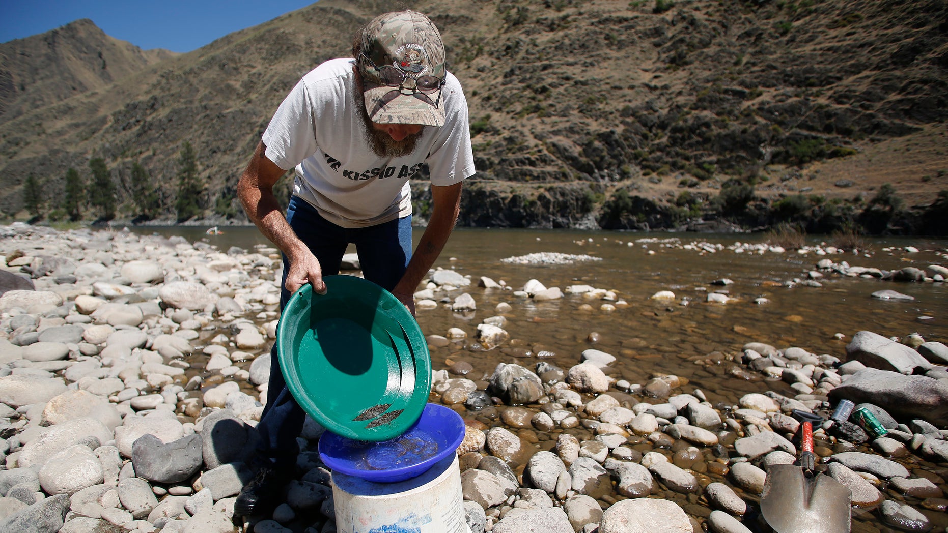 July 3, 2014: B. Dennis Dutcher pans for gold along the Salmon River near Riggins, Idaho.