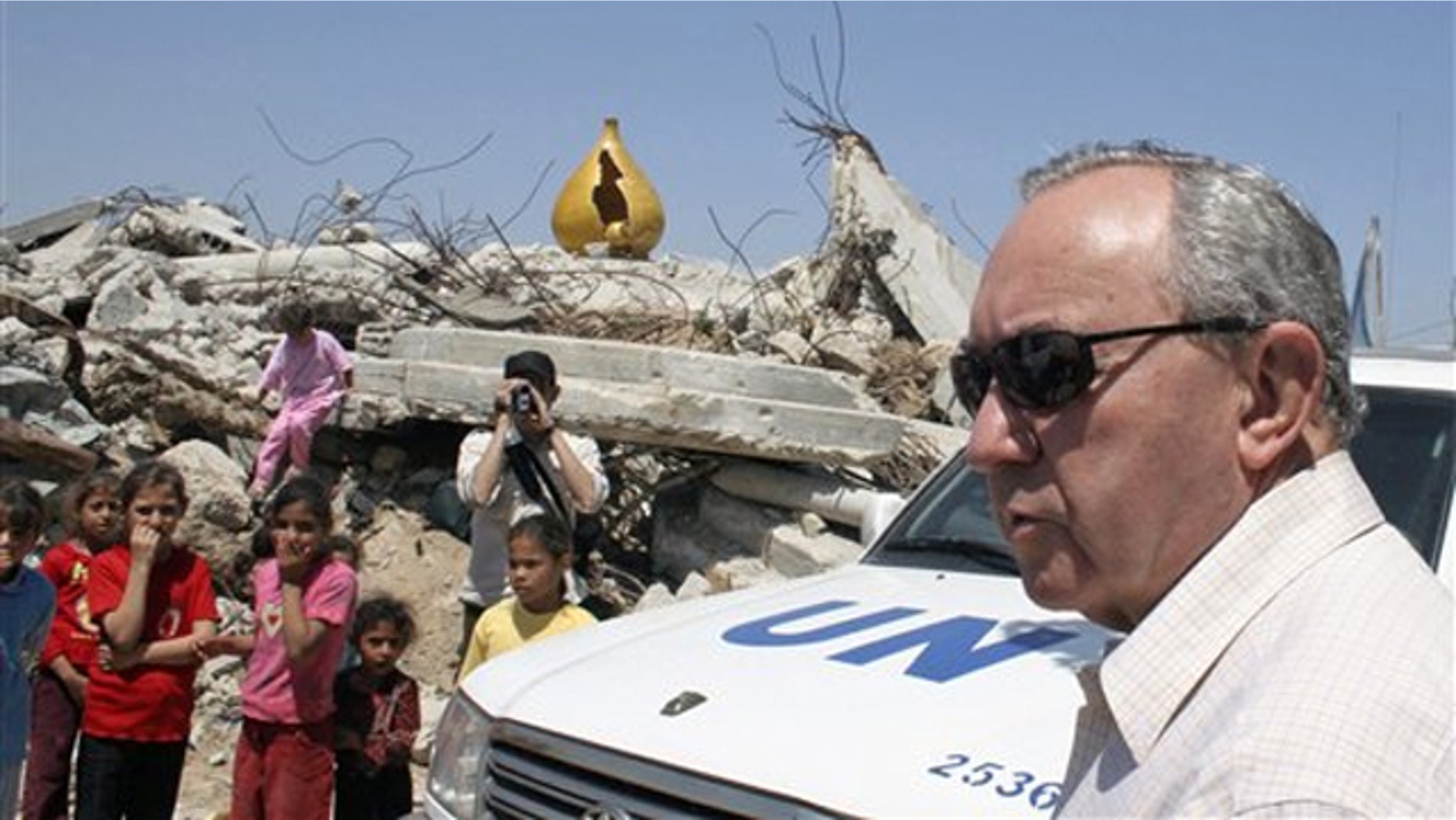 FILE: In this June 3, 2009, photo, U.N. investigator Richard Goldstone visits a house destroyed during an artillery strike during Israel's offensive in January 2009 in Gaza City.