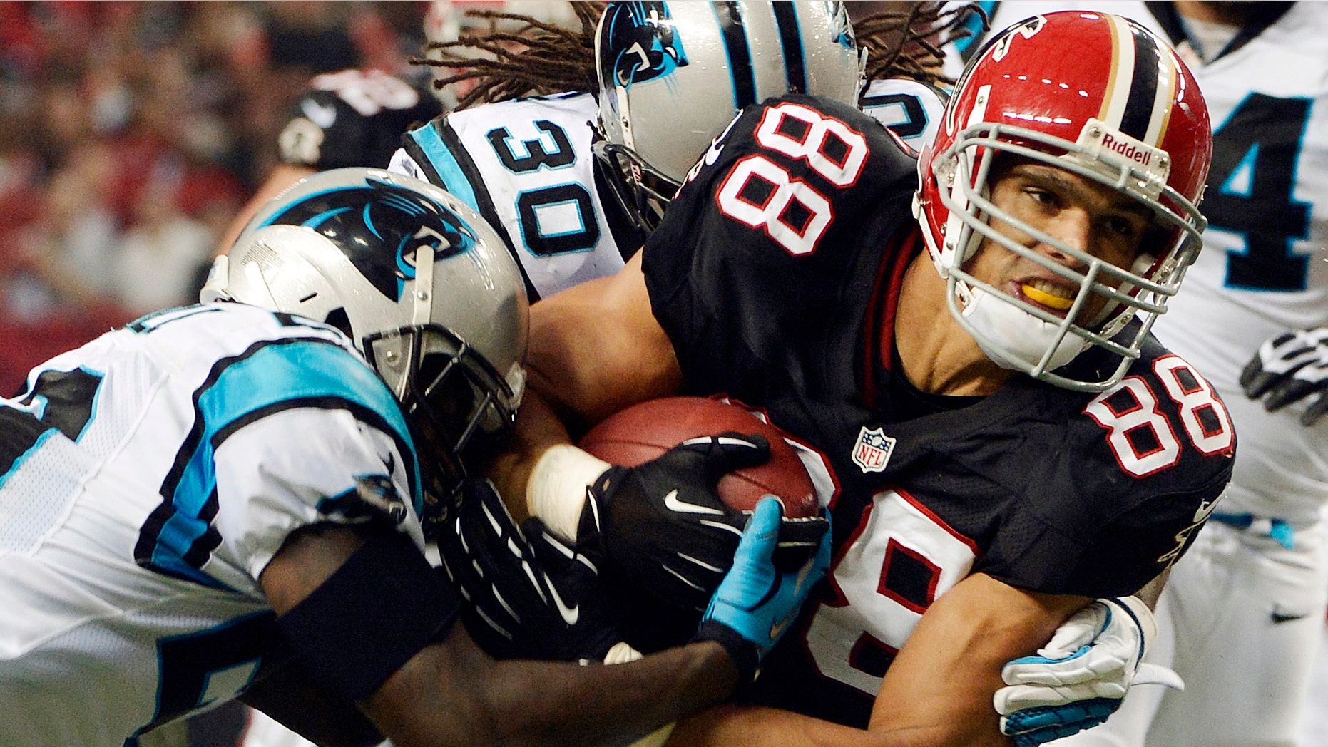 FILE - In this Sept. 30, 2012, file photo, Atlanta Falcons tight end Tony Gonzalez (88) fights for extra yardage during the first half of an NFL football game against the Carolina Panthers in Atlanta. Gonzalez wants to go out with a ring. First, he's got to win a playoff game. In what he keeps insisting will likely be his final season, the Falcons' age-defying tight end is looking forward to taking another shot at his first postseason victory. (AP Photo/Rich Addicks, File)