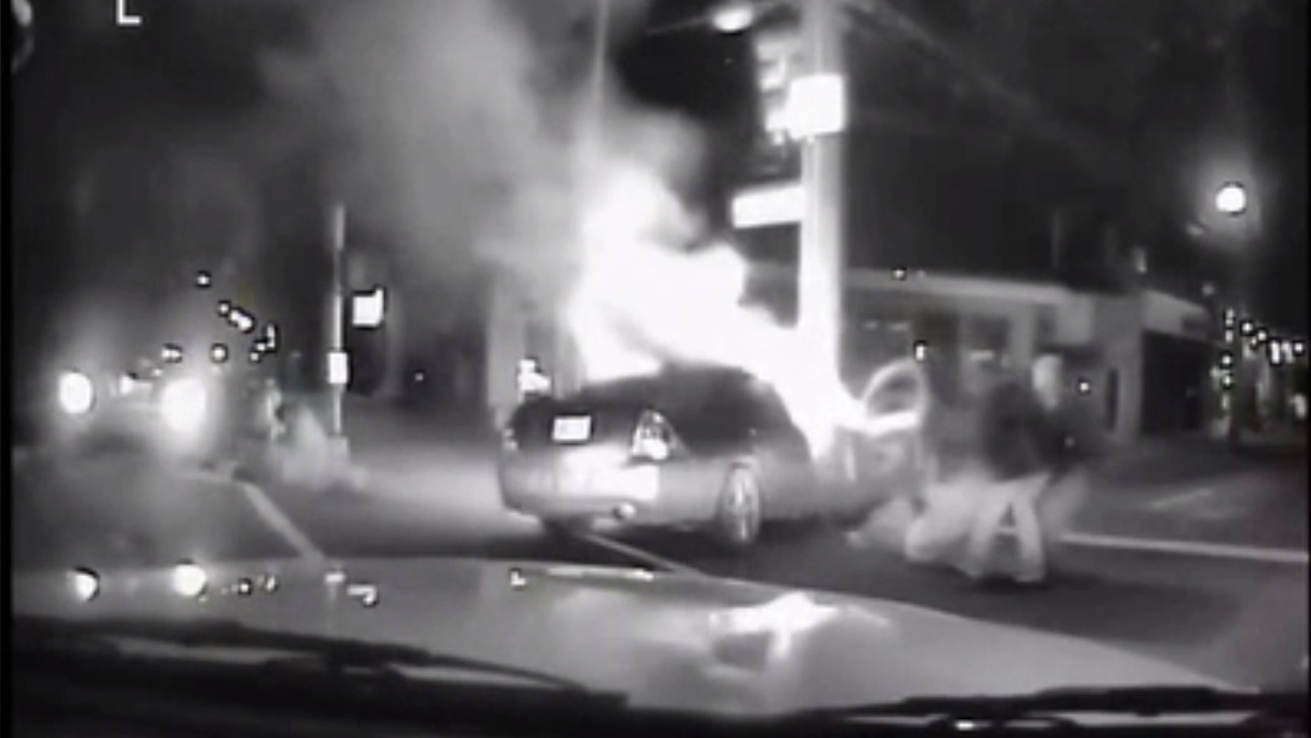 A Good Samaritan and a Louisville police officer saved two people from a burning car.