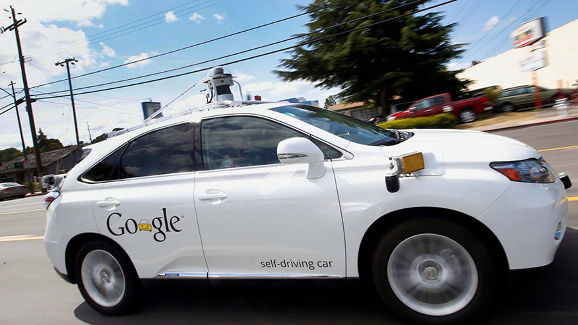 FILE - In this May 13, 2015 file photo, Google's self-driving Lexus car drives along street during a demonstration at Google campus in Mountain View, Calif. A House panel on Wednesday, July 19, 2017, backed legislation designed to allow automakers to increase the testing of self-driving cars on U.S. roads. (AP Photo/Tony Avelar, File)