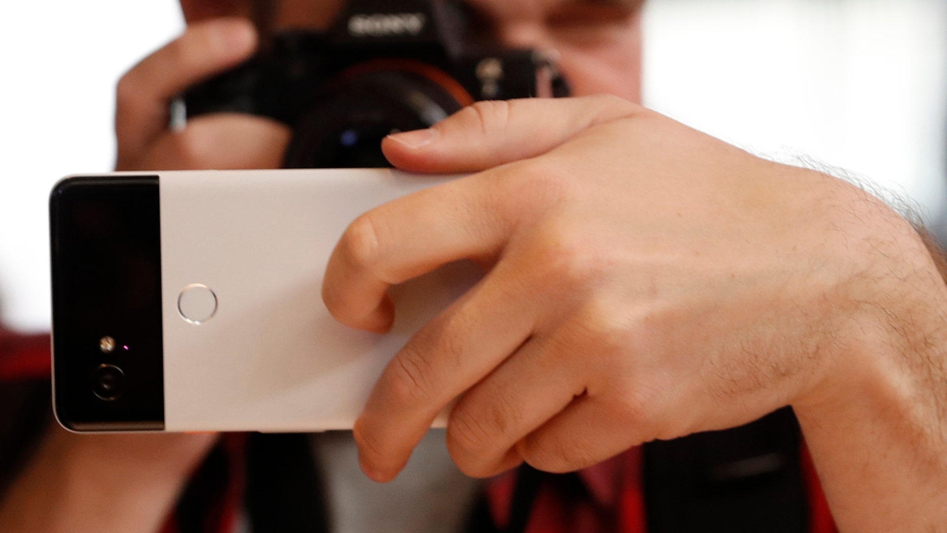 File photo: A man takes a photo of a Google Pixel 2 phone during a launch event in San Francisco, California, U.S. October 4, 2017. REUTERS/Stephen Lam