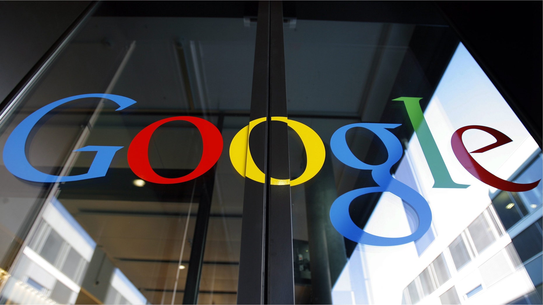FILE - In this March 6, 2008 file photo, the Google logo is seen on the front door of the new Google Engineering center in Zurich, Switzerland. European regulators appeared on Tuesday, Oct. 1, 2013 to be nearing a settlement with Google in their probe over whether the Internet search and advertising giant is unfairly stifling competition. (AP Photo/Keystone, Walter Bier, File)