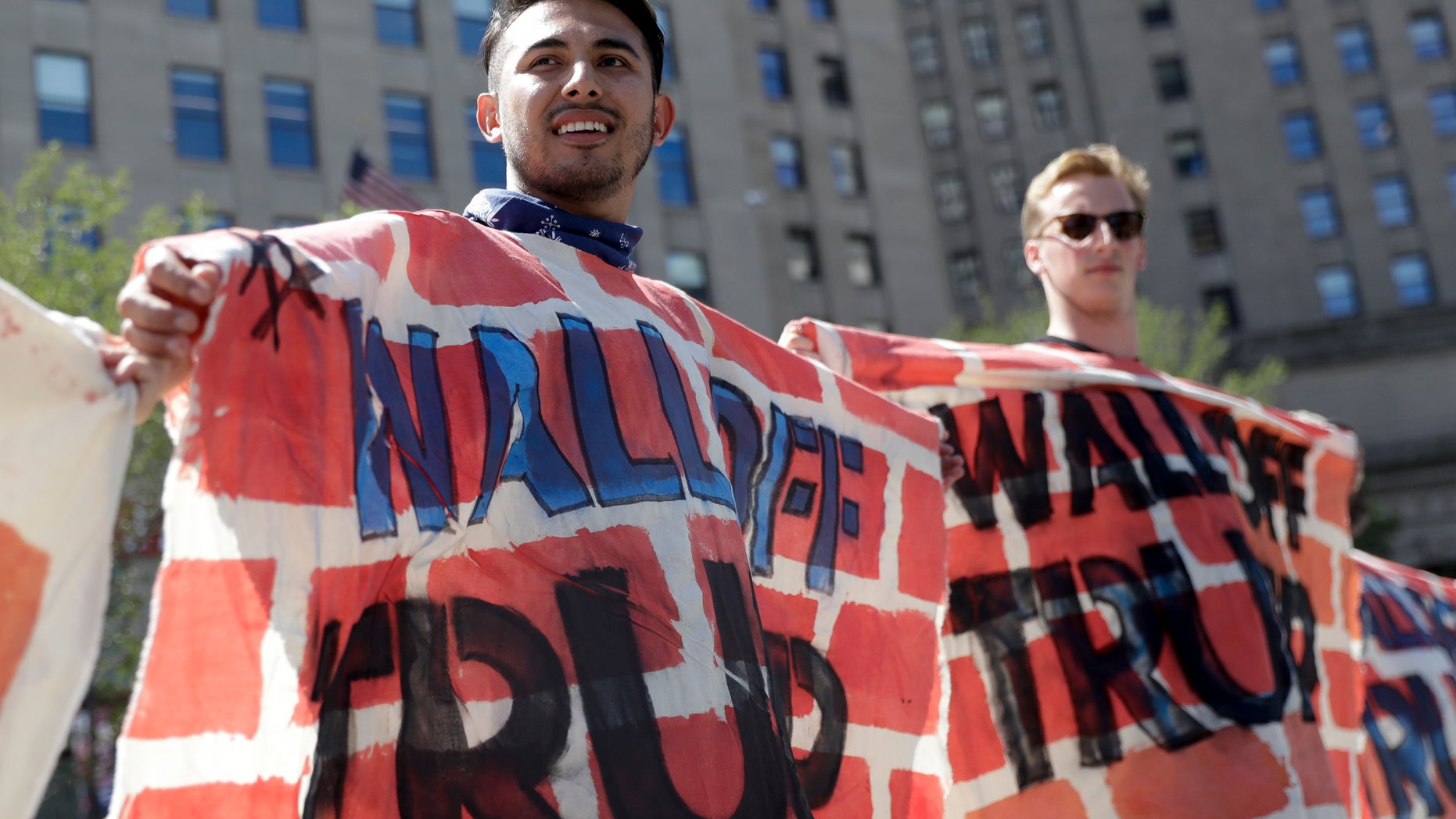 July 20, 2016: Immigrant rights activists hold up a fabric wall to protest Republican presidential candidate Donald Trump's border wall idea in Cleveland, during the third day of the Republican convention.