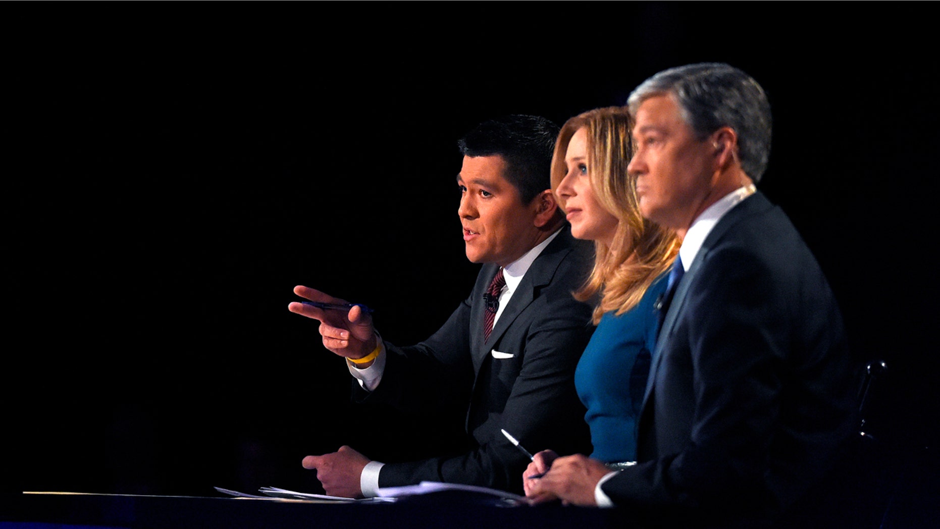 Debate moderators Carl Quintanilla, left, Becky Quick, center, and John Harwood appear during the CNBC Republican presidential debate at the University of Colorado, Wednesday, Oct. 28, 2015, in Boulder, Colo. (AP Photo/Mark J. Terrill)