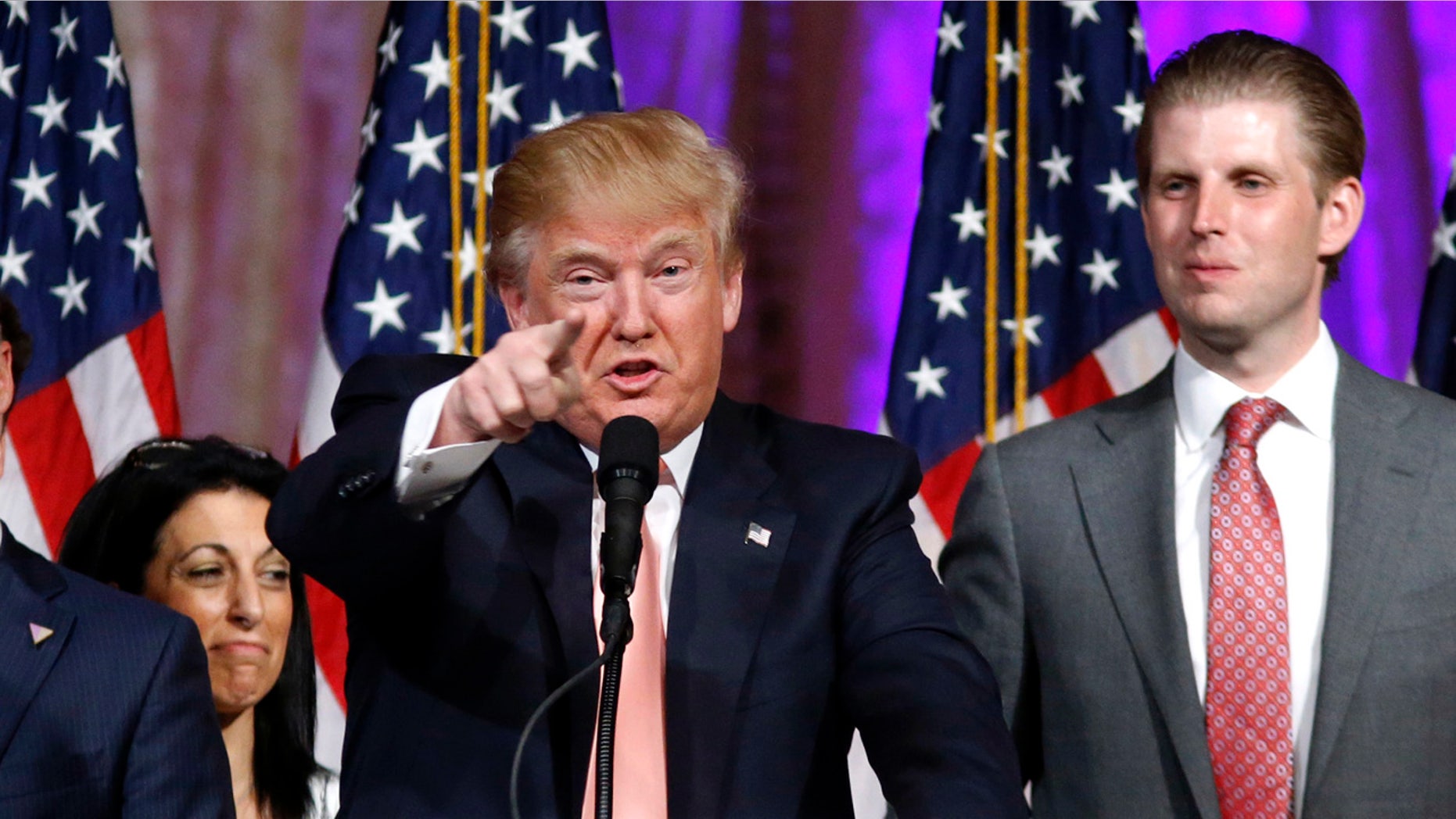 Republican presidential candidate Donald Trump speaks to supporters at his primary election night event at his Mar-a-Lago Club in Palm Beach, Fla., Tuesday, March 15, 2016. at right is his son Eric Trump (AP Photo/Gerald Herbert)