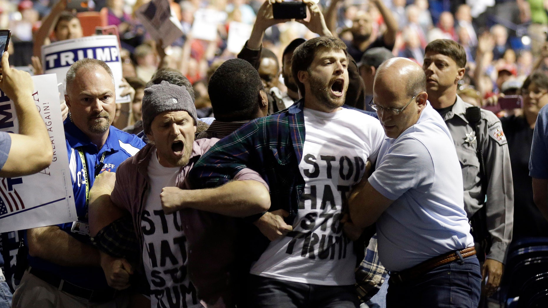 Protesters are removed from a Donald Trump rally in Fayetteville, N.C.