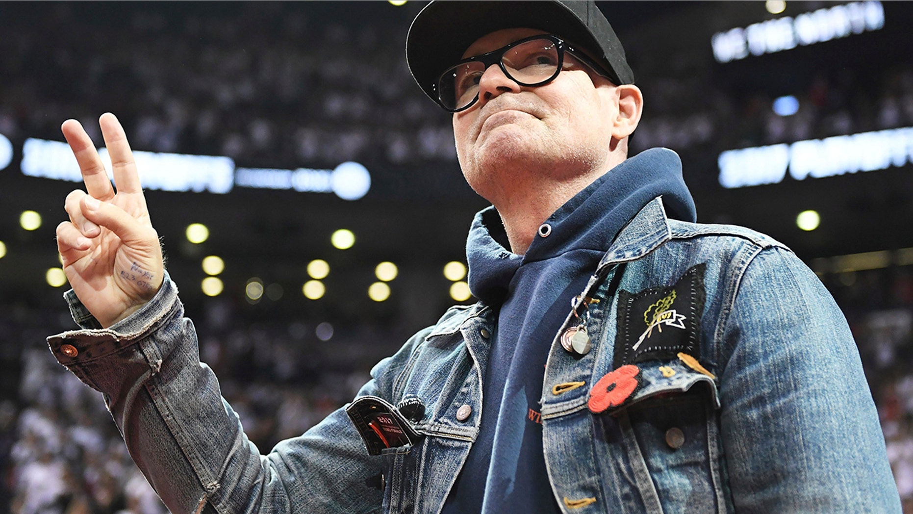 In this May 5, 2017 file photo, lead singer of The Tragically Hip Gord Downie salutes fans during the first half of Game 3 of an NBA basketball second-round playoff series between the Toronto Raptors and the Cleveland Cavaliers in Toronto. The widely revered lead singer died Tuesday night, Oct. 17, 2017.