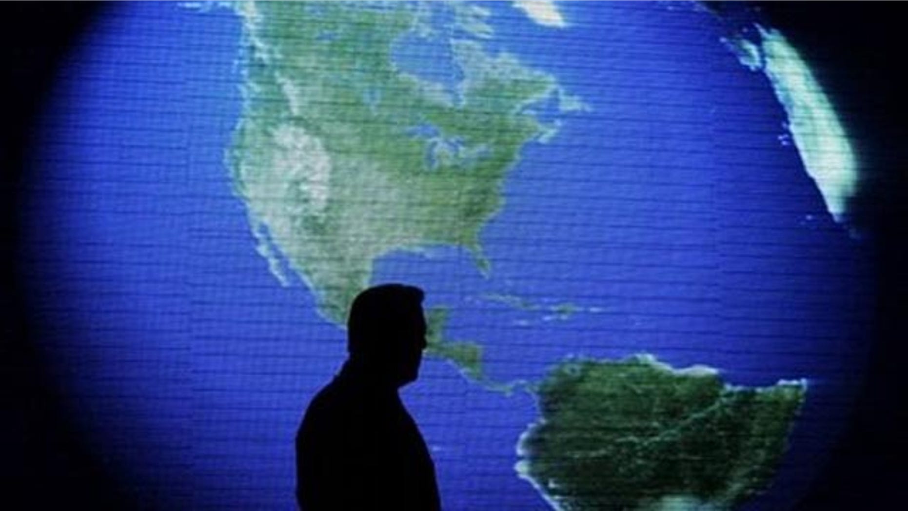 FILE: Former U.S. Vice President and environmentalist Al Gore is silhouetted against an image of the earth during his June 8 talk about climate change in Manila, Philippines. Gore said at a green energy business conference in Athens that lobbyists have wrongly kept alive the ethanol program he once touted.
