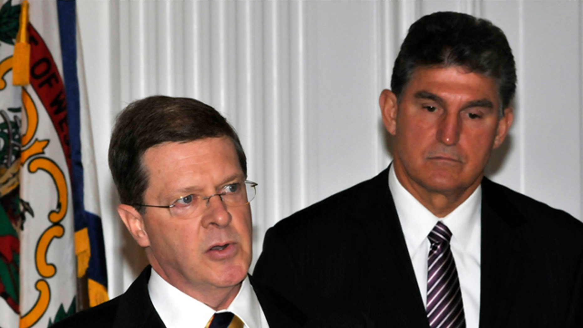 Oct. 6, 2010: Ben Bailey, hired by the state of West Virginia to file a lawsuit against the Obama administration's efforts to curb mountaintop removal coal mining, speaks as W.Va. Gov. Joe Manchin, right, listens at the Capitol in Charleston, W.Va.