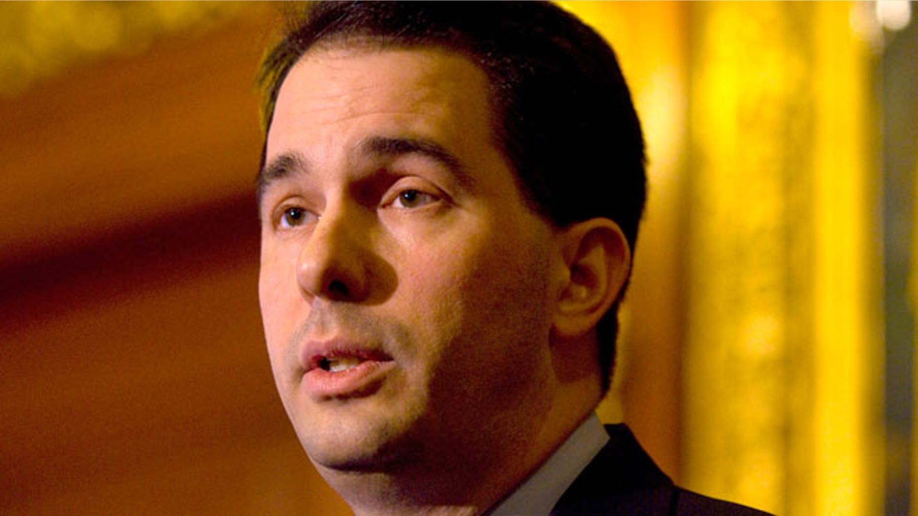 FILE: Wisconsin Republican Gov. Scott Walker says a middle school teacher who viewed pornography on his classroom computer but was allowed to return to work should have his license revoked.