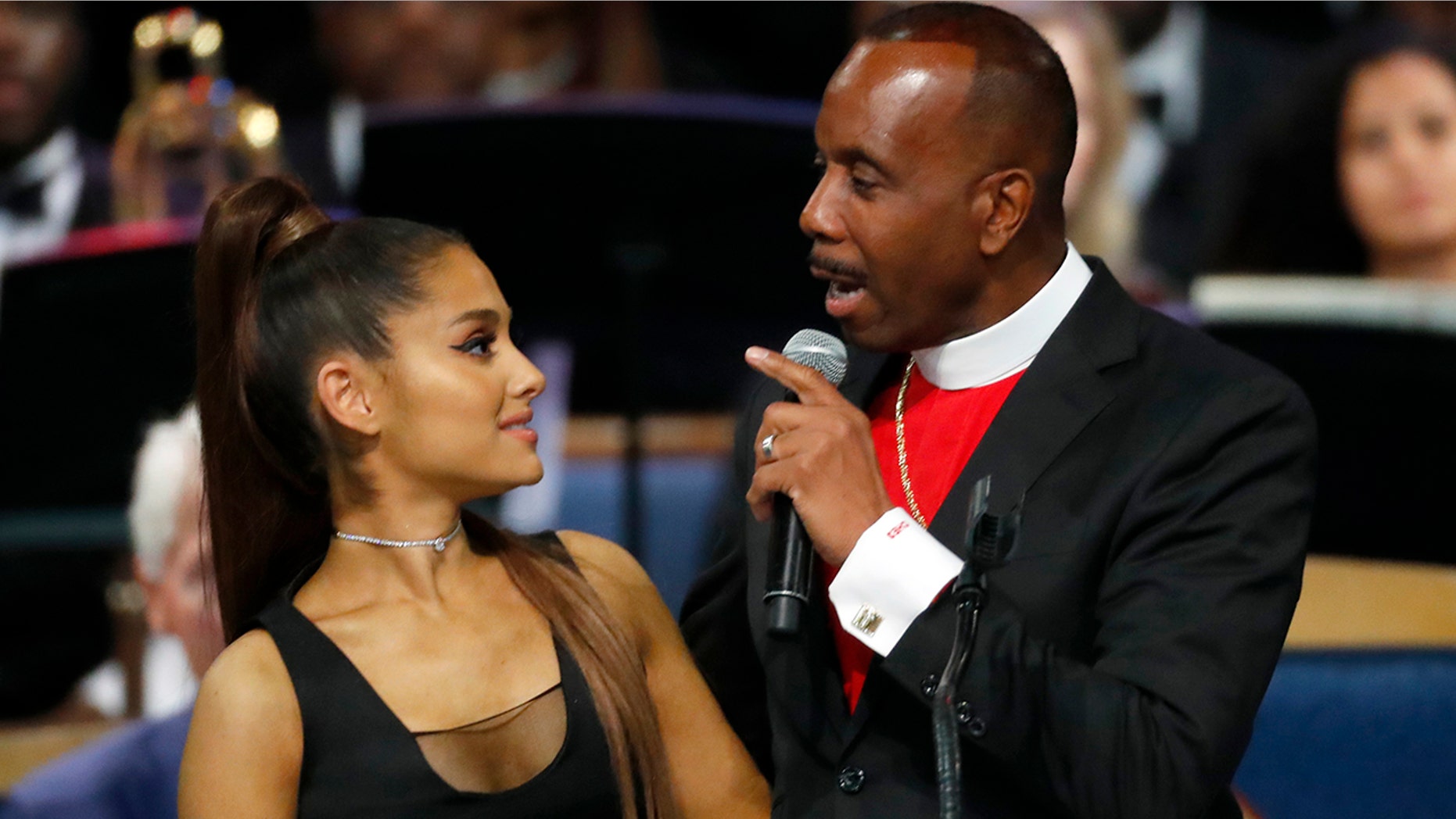 Bishop Charles H. Ellis, III, right, speaks with Ariana Grande after she performed during the funeral service for Aretha Franklin at Greater Grace Temple in Detroit, Aug. 31, 2018.
