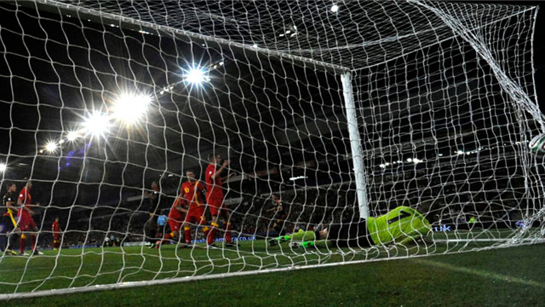 FILE: Players for the Wales and Belgium teams compete in a soccer match.