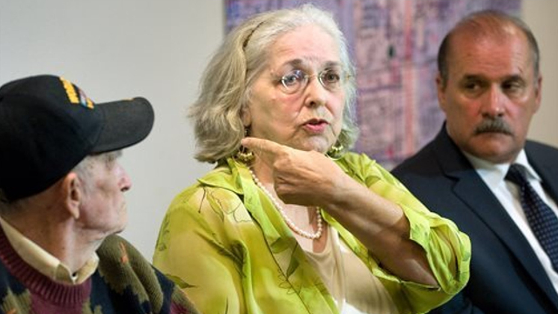 June 11, 2013: Jan Cooper, 72, talks to the media as her husband Bob, 85, left, and OC Sheriff's spokesman Jim Amormino listen during a news conference at the Sheriff's Department station in Stanton.