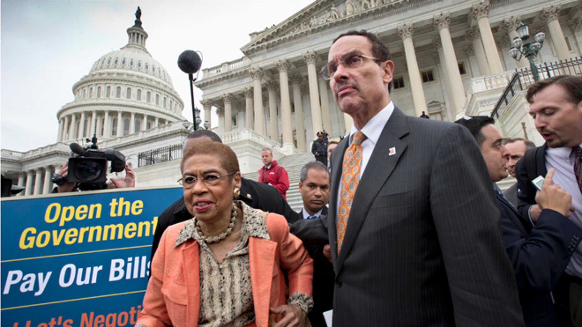 Oct. 9, 2013: Washington Mayor Vincent Gray, right, and Del. Eleanor Holmes Norton, D-D.C., left, make their way through the crowd after joining a Senate Democratic press conference in Washington.