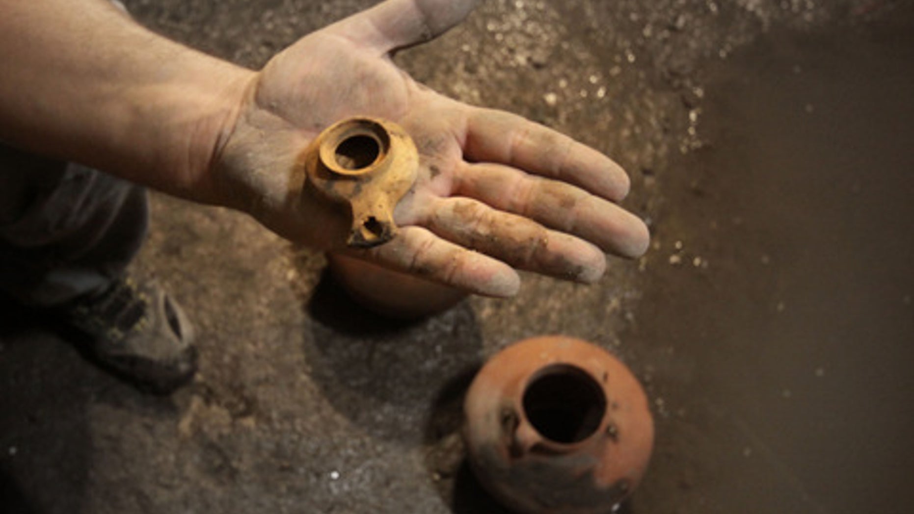 This ceramic oil lamp and two cooking pots were found in a cistern in Jerusalem and date back to the first Jewish revolt against the Romans (A.D. 66-73).