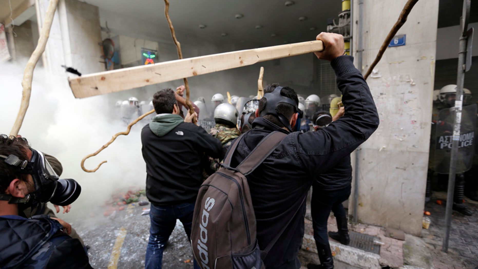 Feb. 12, 2016: Farmers clash with riot police during a protest outside Agriculture ministry in Athens.