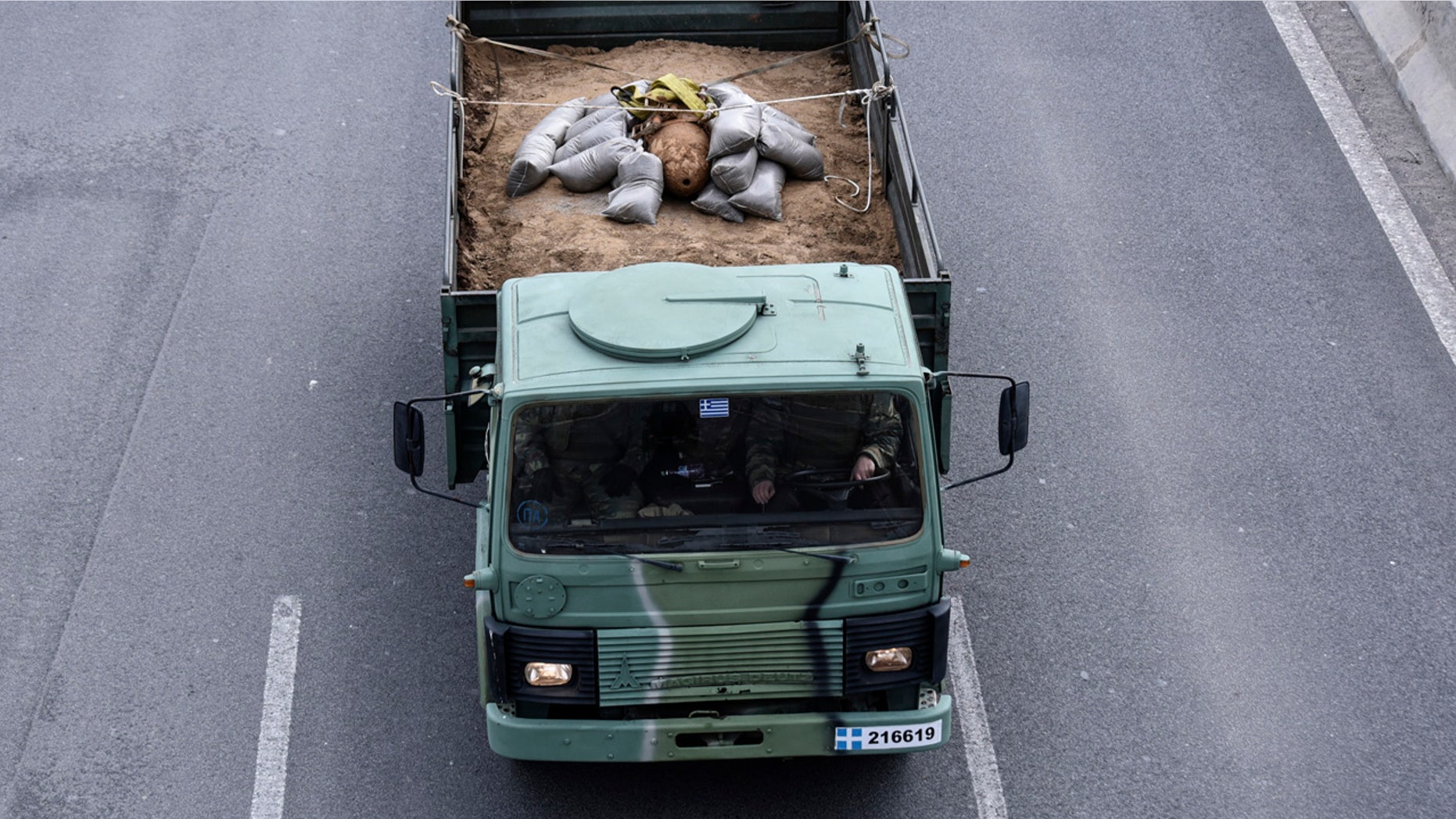 A military truck carries an unexploded World War II bomb which was defused by Greek Army personnel in Thessaloniki, Greece Sunday, Feb. 12, 2017.