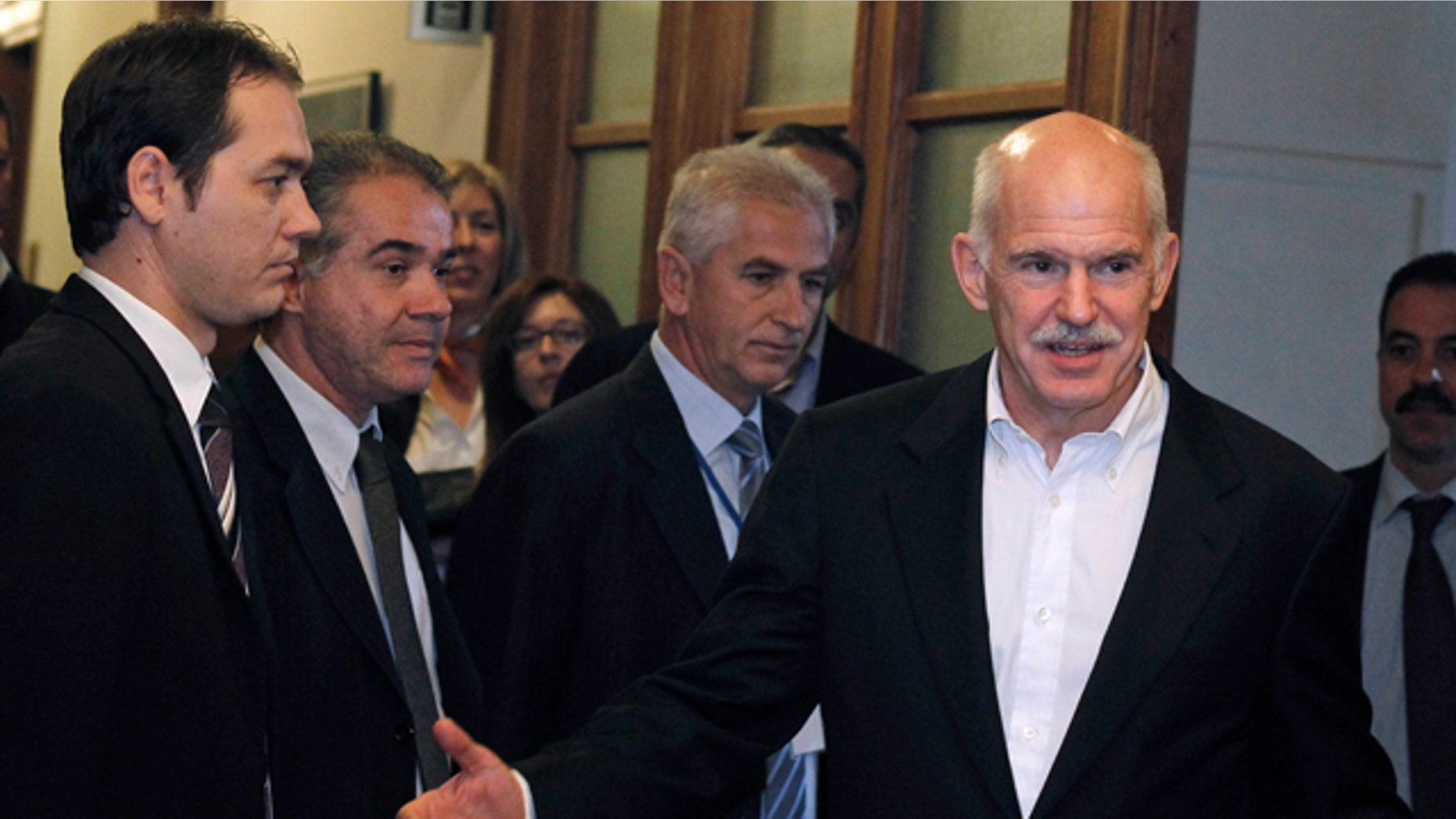 Nov. 8, 2011: Greek Prime Minister George Papandreou, right, gestures as he arrives for a cabinet meeting at the parliament in Athens.