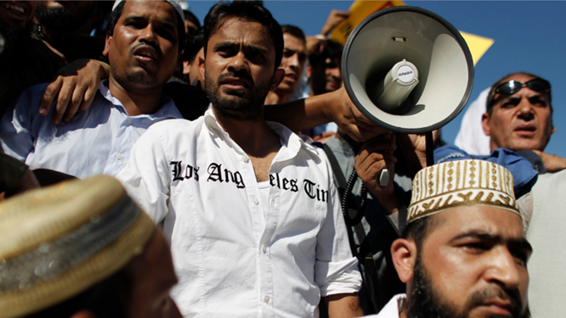 Sun. 23, 2012: A man wears a shirt bearing the name of an American newspaper, as Muslim protest against a film produced in the U.S. that they say insults the Prophet Muhammad, in Athens.