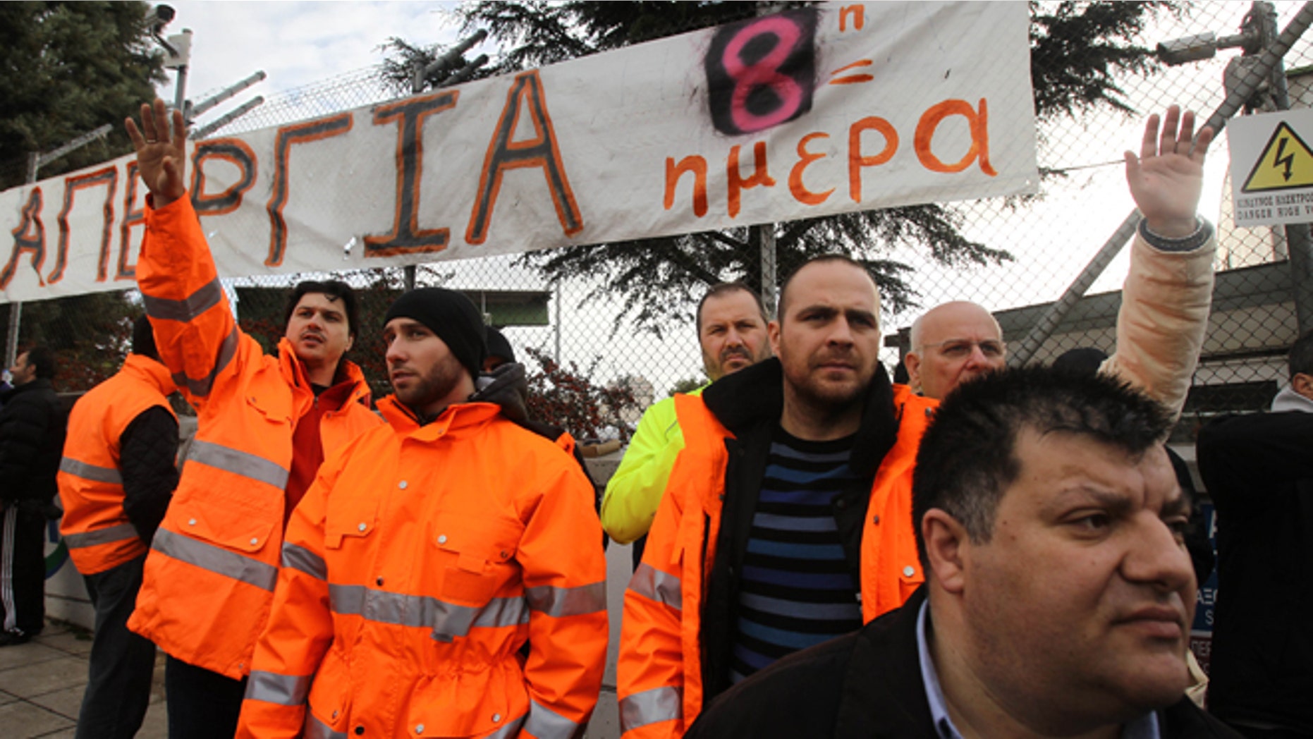 Jan. 24, 2013: Striking metro workers stand under a banner that reads: "Strike 8th Day" at the the central depot in Athens.