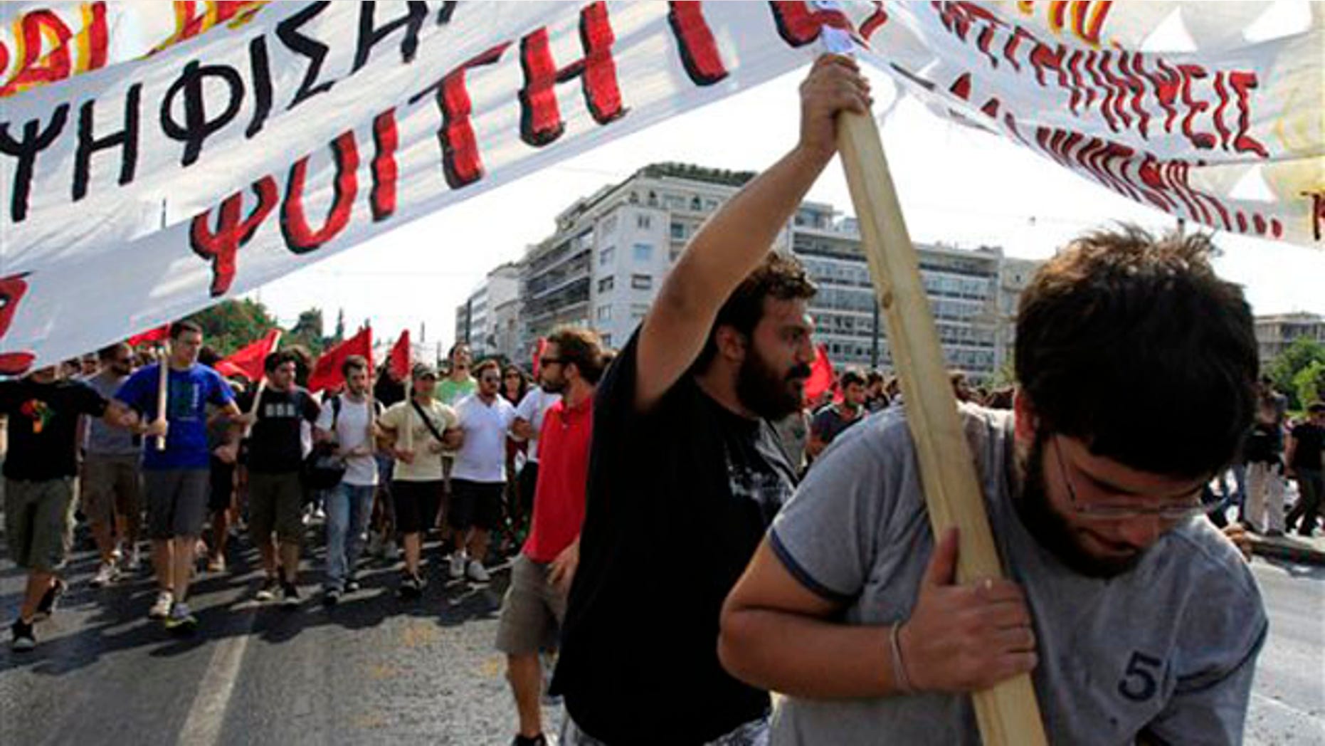 University students try to hold a banner during a protest in Athens, Thursday, Sept. 8, 2011.