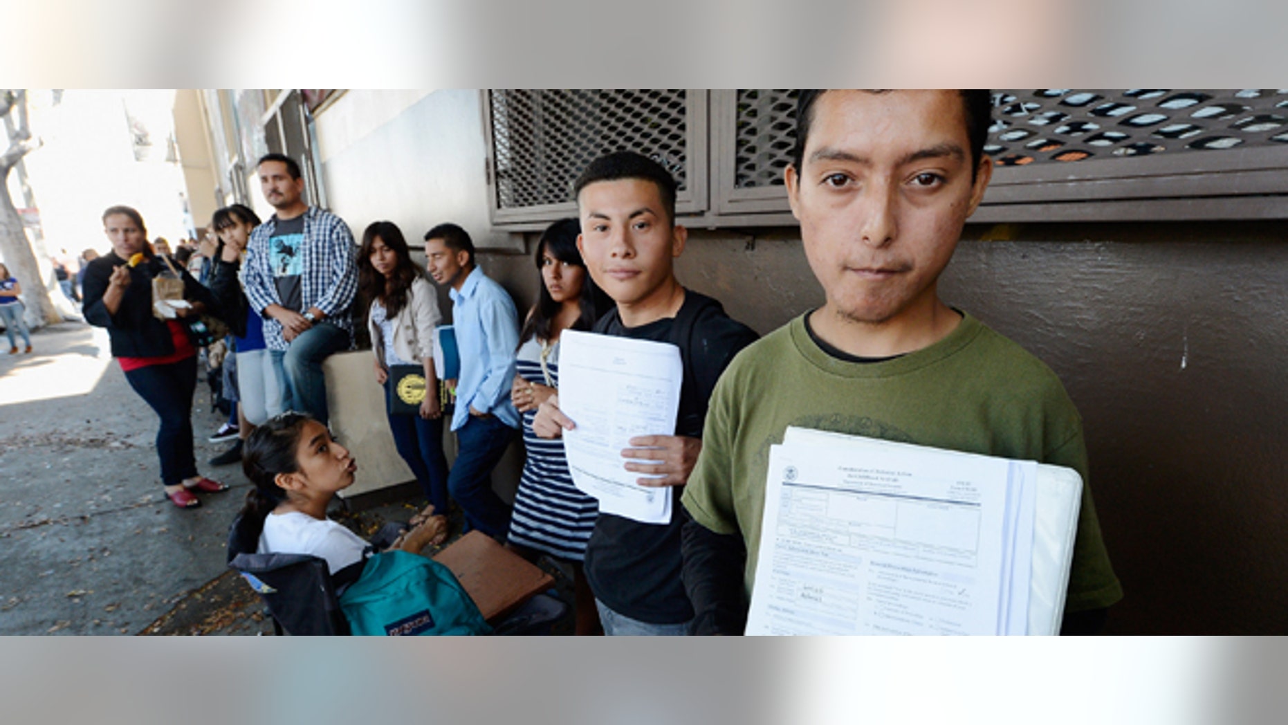 LOS ANGELES, CA - AUGUST 15: Roberto Larios, 21, (R) holds Deferred Action for Childhood Arrival application as he waits in line with hundreds of fellow undocumanted immigrants at the Coalition for Humane Immigrant Rights of Los Angeles offices to apply for deportation reprieve on August 15, 2012 in Los Angeles, California. Under a new program established by the Obama administration undocumented youth who qualify for the program, called Deferred Action for Childhood Arrivals, can file applications from the U.S. Citizenship and Immigration Services website to avoid deportation and obtain the right to work (Photo by Kevork Djansezian/Getty Images)