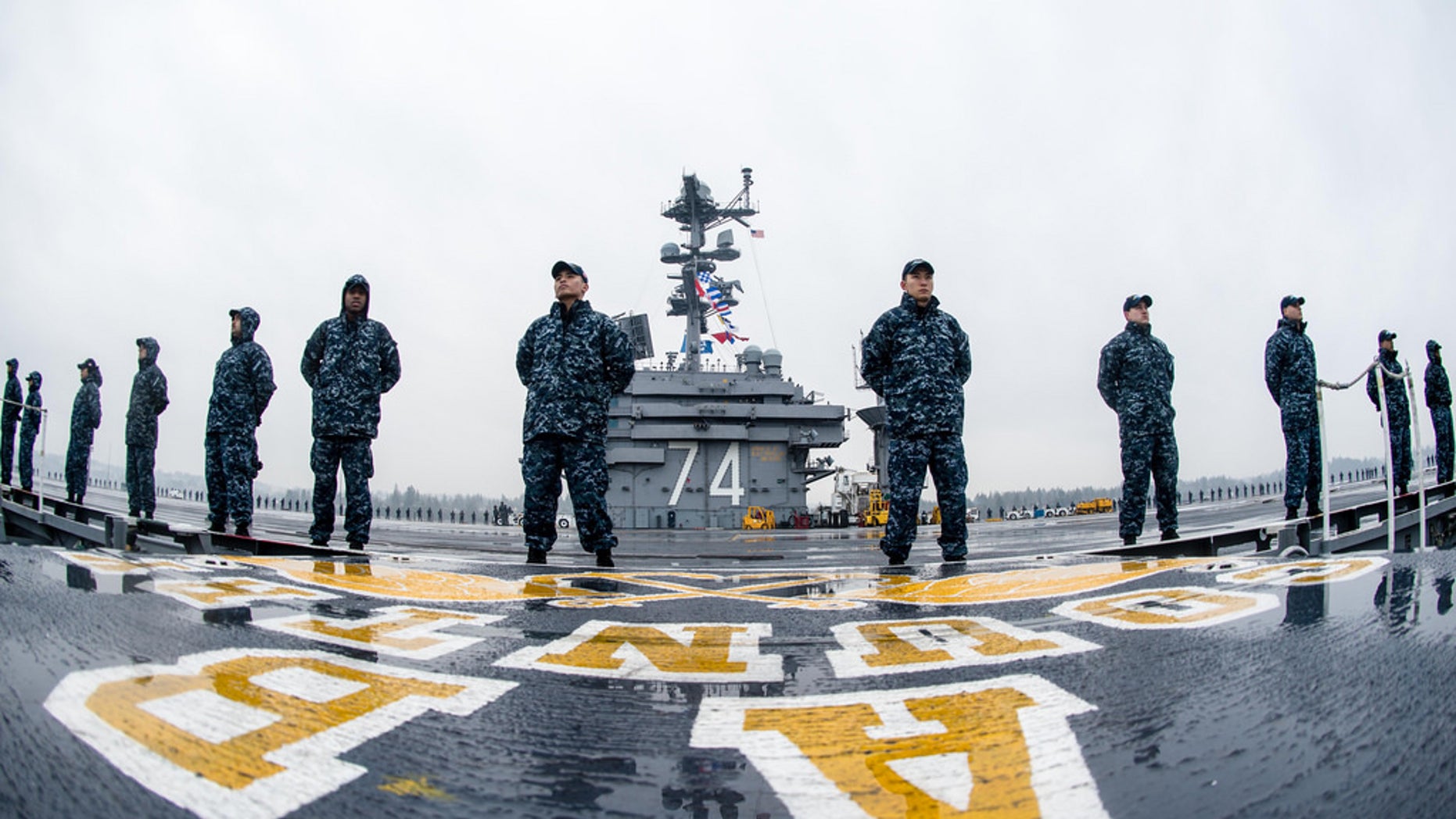 Sailors man the rails aboard USS John C. Stennis' (CVN 74) flight deck as the aircraft carrier gets underway for a deployment that will include operations in both the U.S. 3rd Fleet and U.S. 7th Fleet areas of responsibility, while also serving, along with its strike group, as the centerpiece of the Great Green Fleet, a year-long initiative highlighting the Navy's efforts to transform its energy use to increase operational capability. (U.S. Navy photo by Mass Communication Specialist 3rd Class Andre T. Richard)