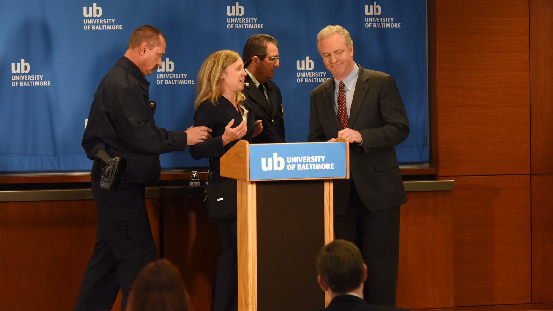 Oct. 26, 2016: Margaret Flowers, center, the Green Party candidate for U.S. Senate in Maryland, is escorted off stage after interrupting a televised Senate debate between Rep. Kathy Szeliga, R-Baltimore County, left, and Rep. Chris Van Hollen, D-Md.,to ask to be included in Baltimore.