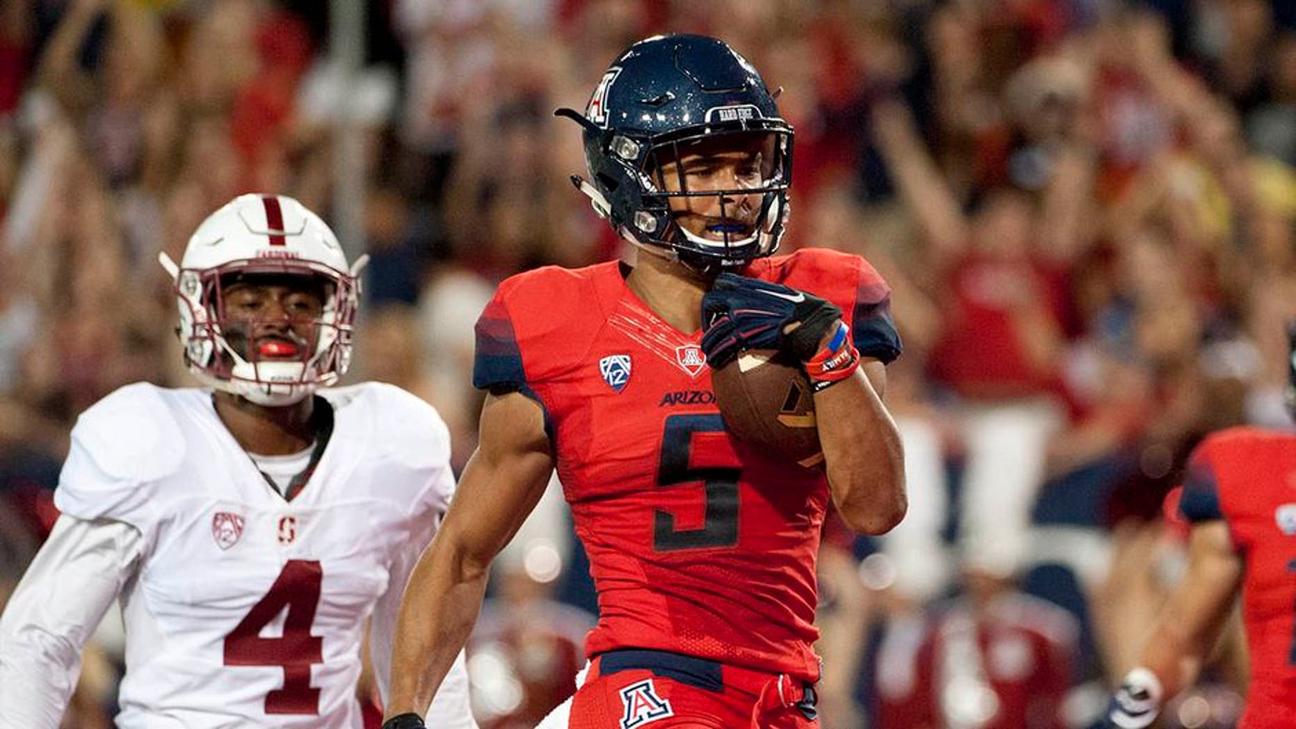 Oct 29, 2016; Tucson, AZ, USA; Arizona Wildcats wide receiver Trey Griffey (5) runs the ball for a touchdown under pressure from Stanford Cardinal cornerback Frank Buncom (4) during the second quarter at Arizona Stadium. Mandatory Credit: Casey Sapio-USA TODAY Sports