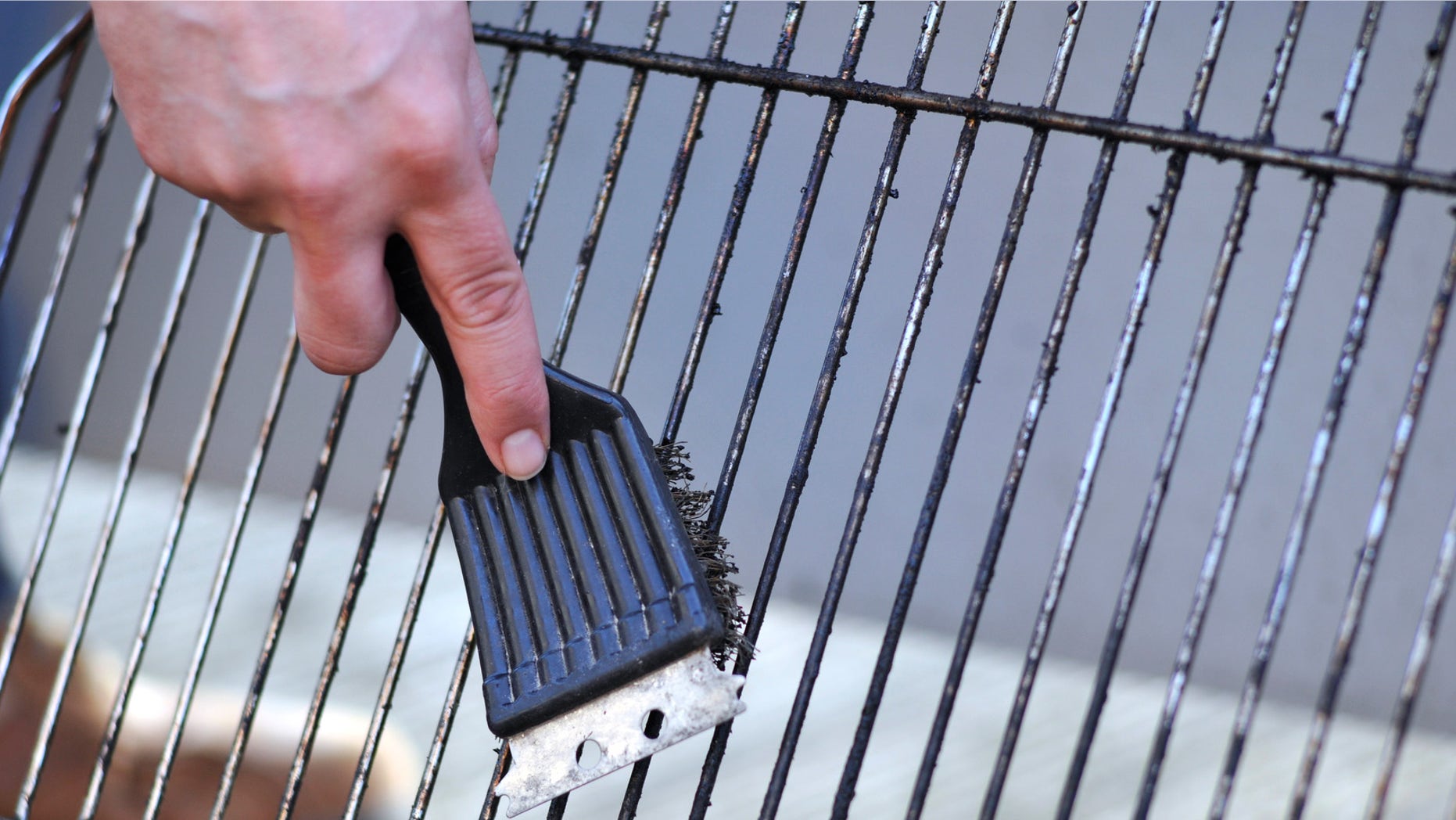 grill being scrubbed