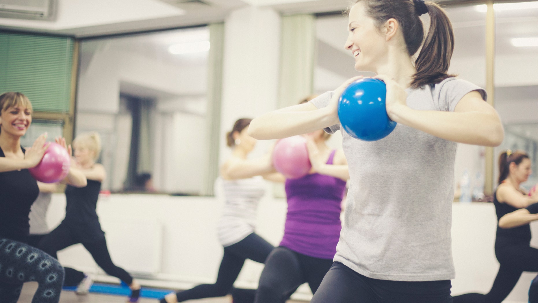 Group portraits of women doing pilates fitnes. Shallow DOF. Developed from RAW; retouched with special care and attention; Adobe RGB color profile.