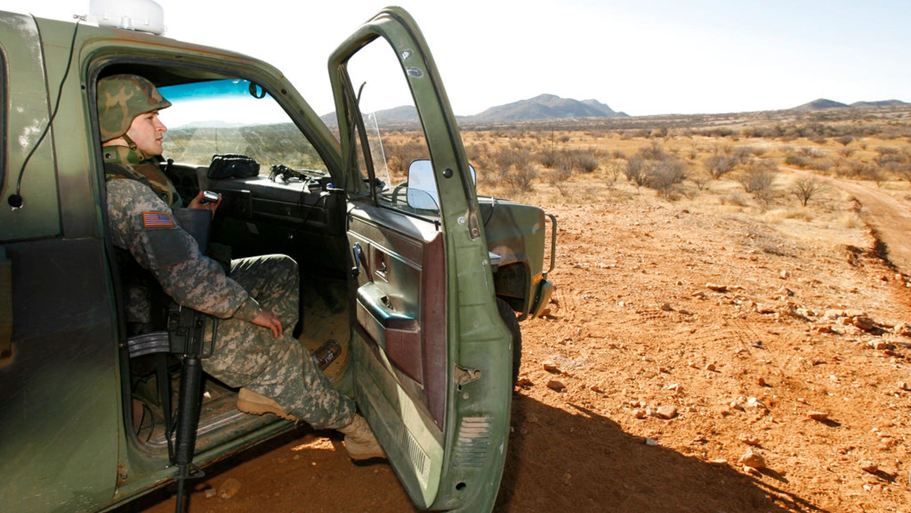 FILE - In this Friday, Jan. 19, 2007 file photo, a National Guard unit patrols at the Arizona-Mexico border in Sasabe, Ariz. President Donald Trump said April 3, 2018, he wants to use the military to secure the U.S.-Mexico border until his promised border wall is built. The Department of Homeland Security and White House did not immediately respond to requests for comment. At the Pentagon, officials were struggling to answer questions about the plan, including rudimentary details on whether it would involve National Guard members, as similar programs in the past have done. But officials appeared to be considering a model similar to a 2006 operation in which former President George W. Bush deployed National Guard troops to the southern border in an effort to increase security and surveillance.(AP Photo/Ross D. Franklin, file)