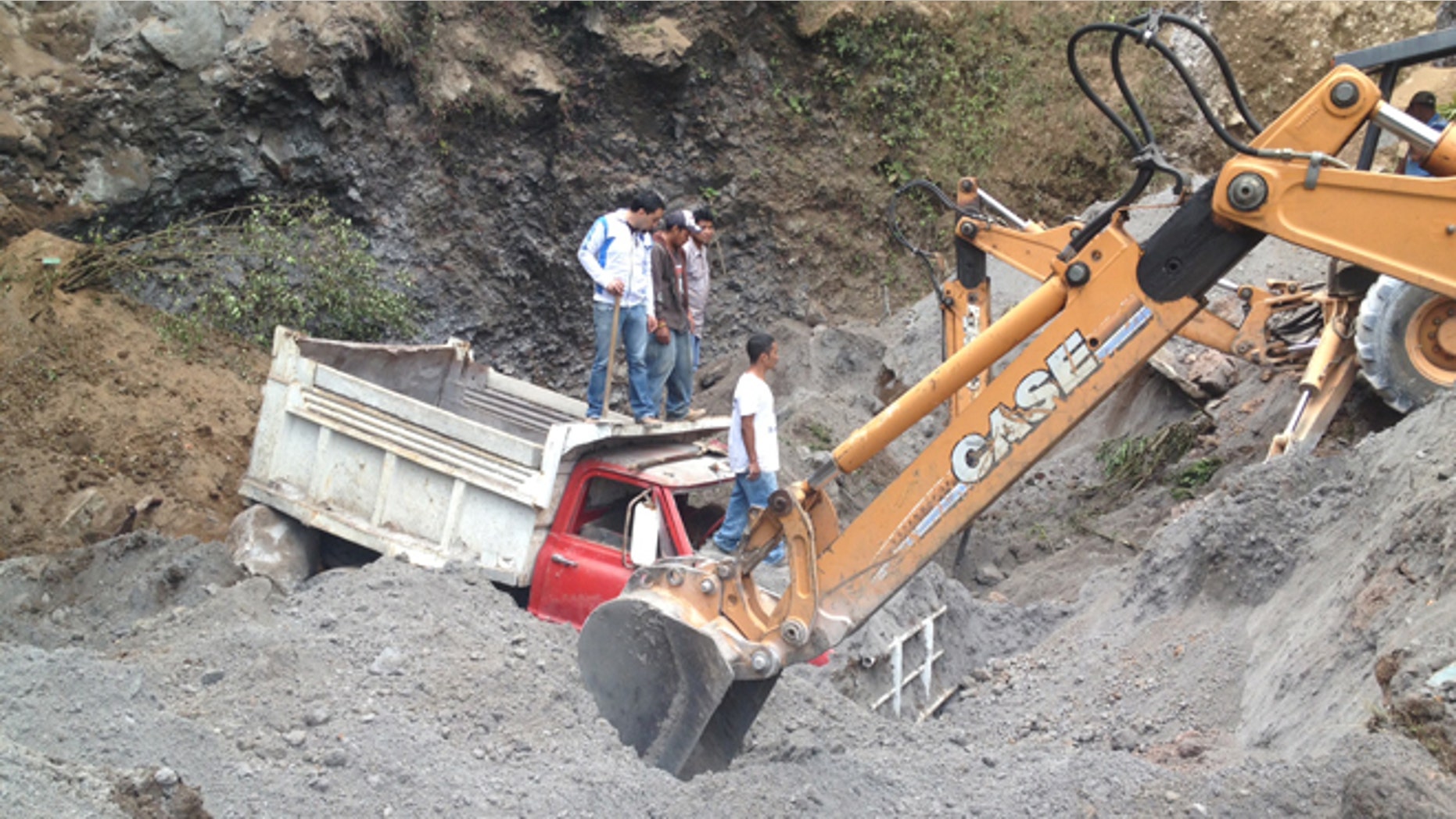 Nov. 7, 2012: Residents use heavy equipment to look for people feared buried at a sand mine, after a magnitude 7.4 earthquake struck in San Marcos, Guatemala.