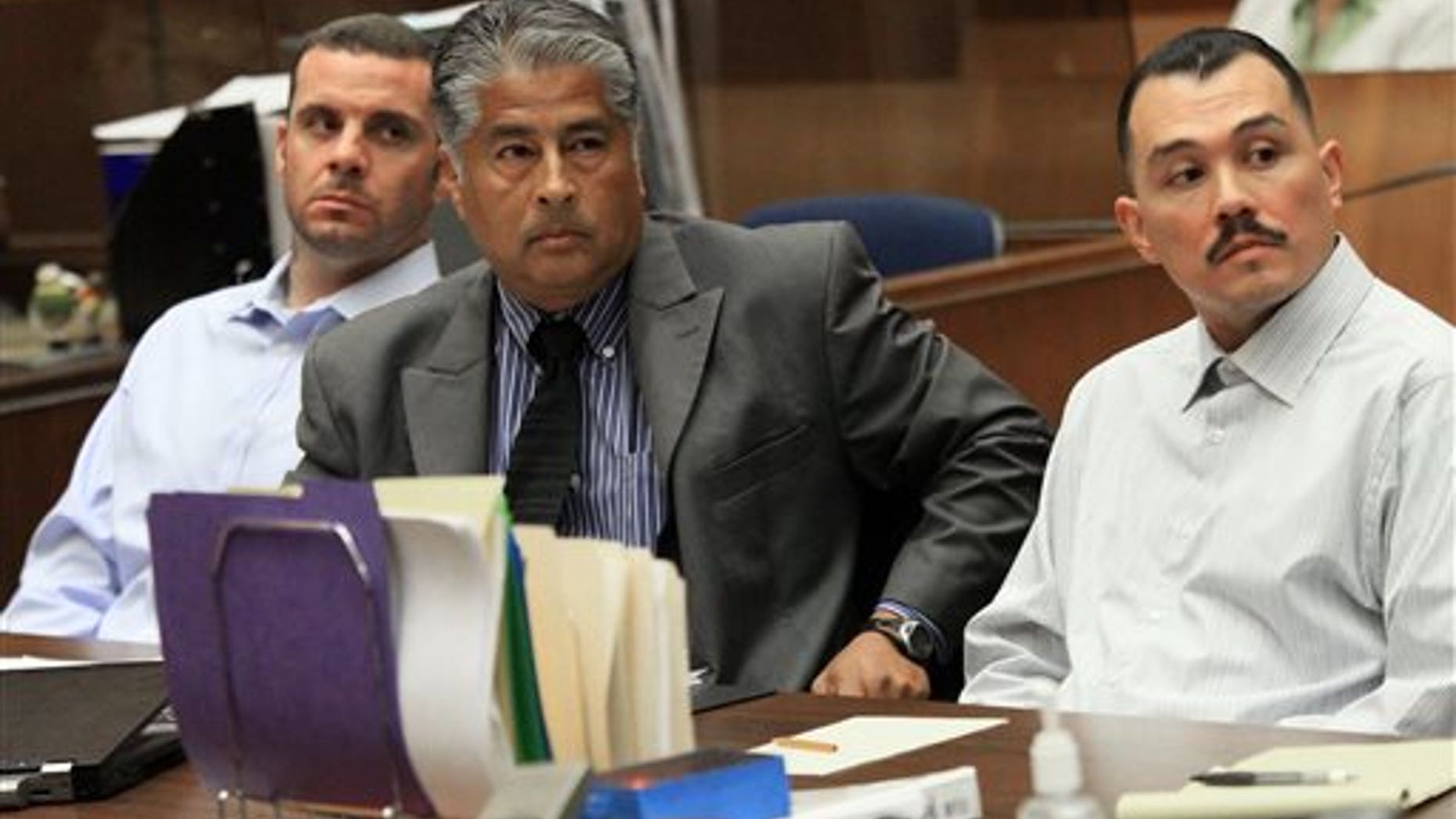FILE - In this May 31, 2012 file photo, Marvin Norwood , left, with attorney Victor Escobedo, center, and co-defendant Louie Sanchez appear during a preliminary hearing held in Los Angeles Superior court. The two men have pleaded guilty on Thursday, Feb. 20, 2014 in Los Angeles to a 2011 beating at Dodger Stadium that left San Francisco Giants fan Bryan Stow brain damaged and disabled. (AP Photo/Los Angeles Times, Irfan Khan, Pool, File)