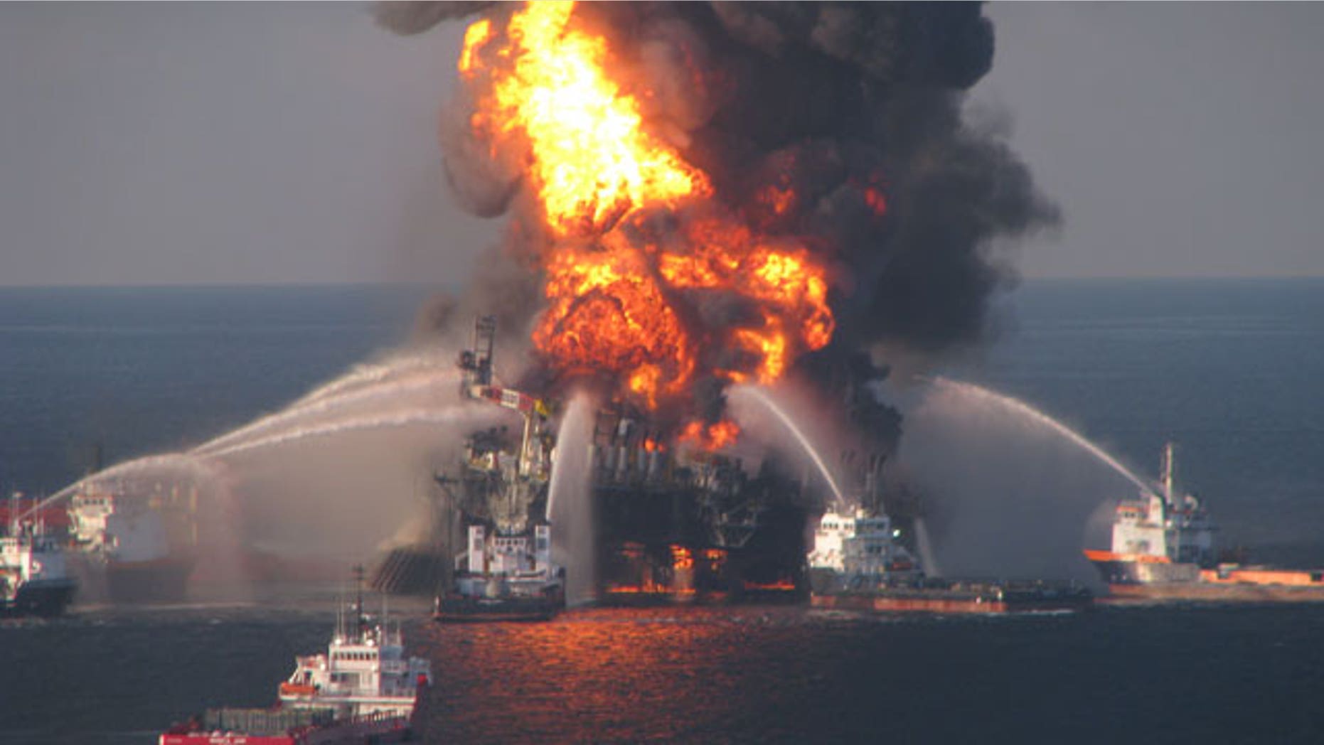 In this April 21, 2010 file photo provided by the U.S. Coast Guard, fire boat response crews spray water on the blazing remnants of BP's Deepwater Horizon offshore oil rig.