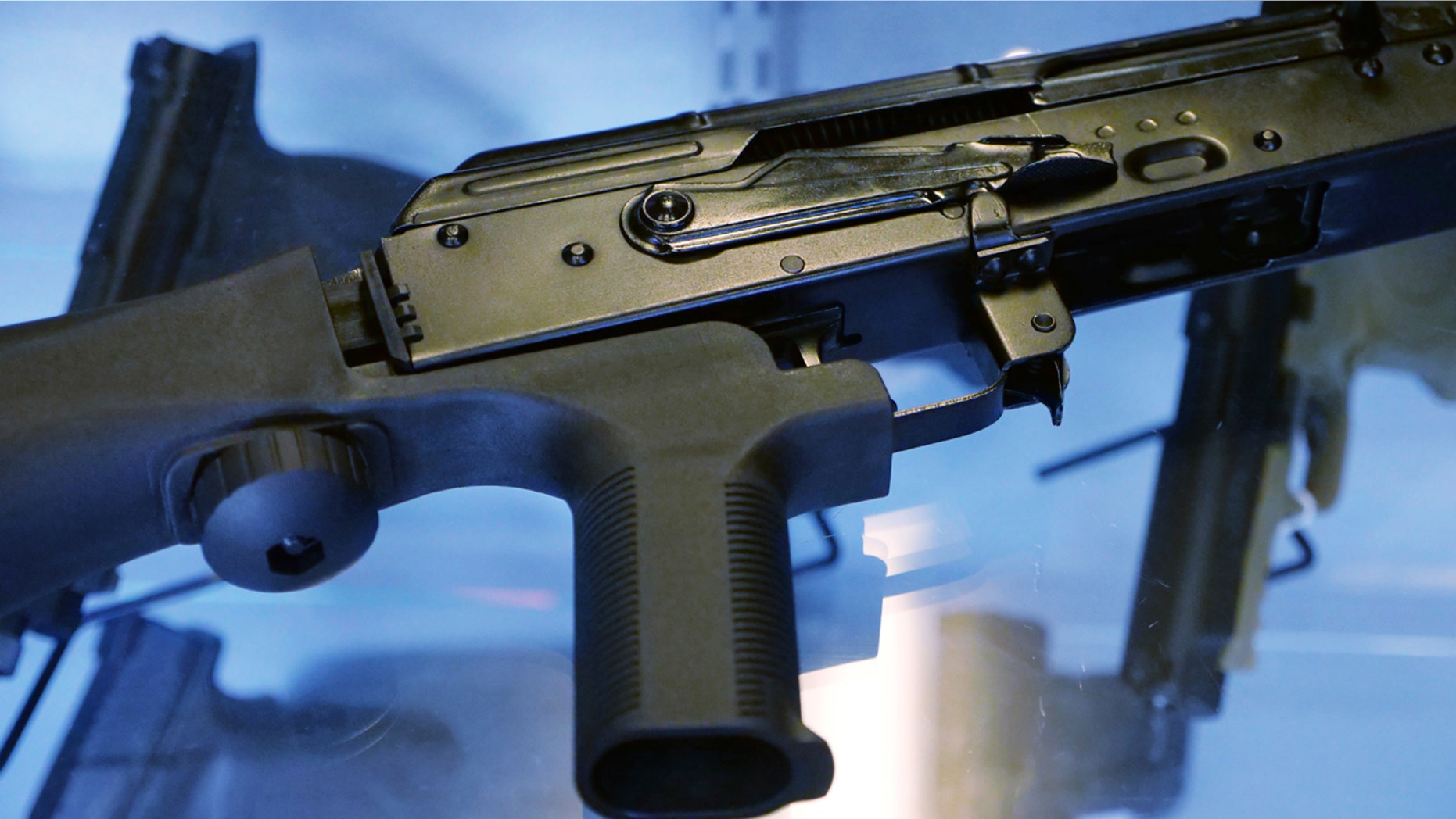 A bump stock is attached to a semi-automatic rifle at the Gun Vault store and shooting range in South Jordan, Utah.