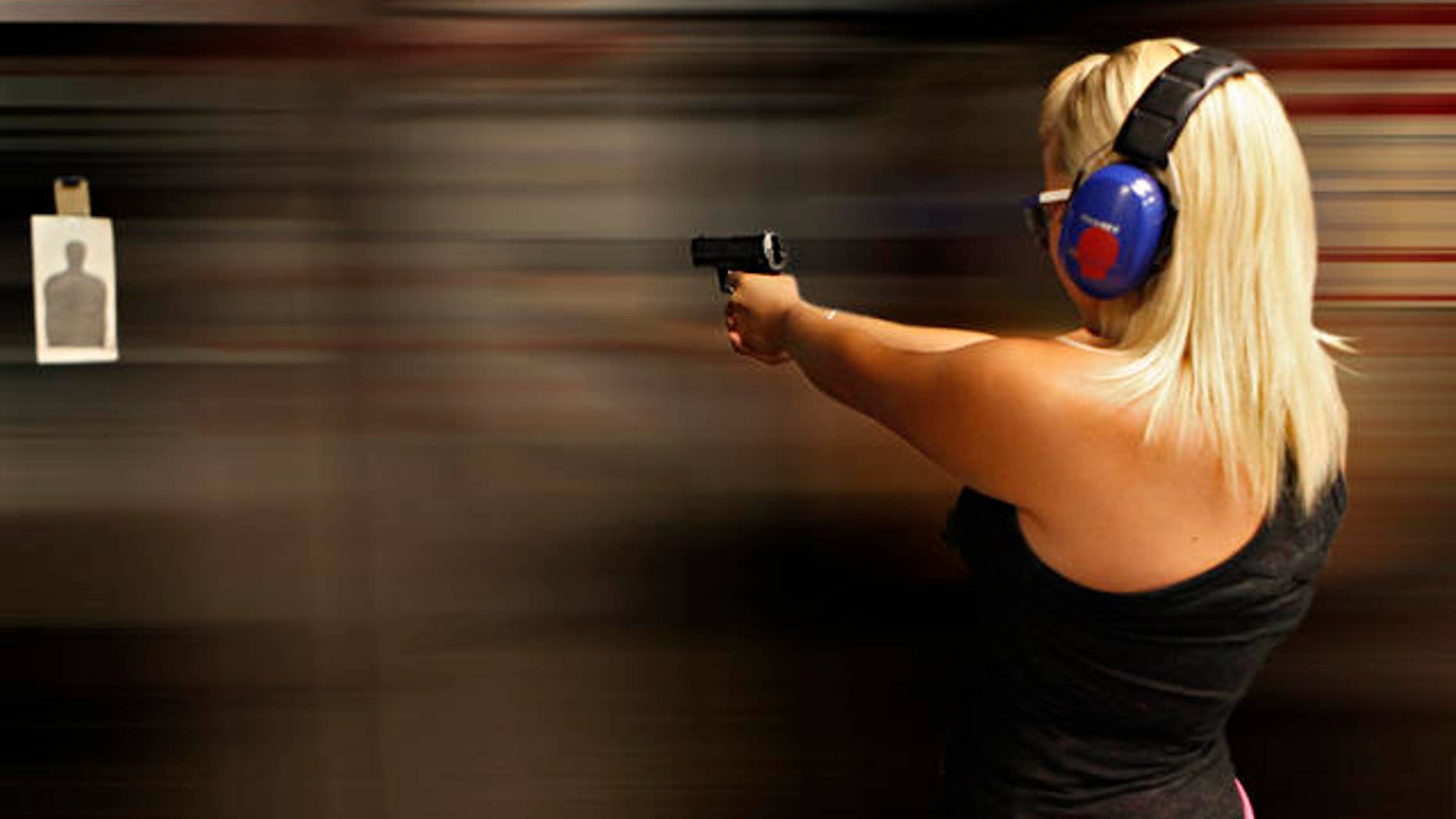 Sarah Bard, of Gilbert, shoots at Caswells Shooting Range, Tuesday, April 6, 2010 in Mesa, Ariz. in preparation for her upcoming concealed weapons test. Gov. Jan Brewer has signed into law two bills supported by gun-rights activists. One of the bills signed Monday would broaden the state's current restrictions on local governments' ability to regulate or tax guns and ammunition. (AP Photo/Matt York)