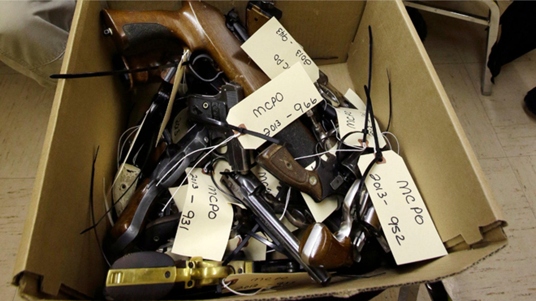 Jan. 26, 2013: Hand guns are seen in a box in Trenton, N.J., during a gun buyback event.