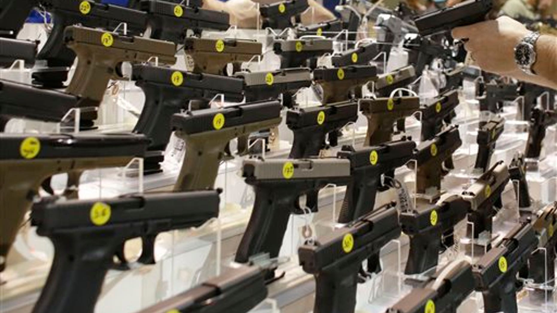 Firearms are on display at a gun show in Miami, Fla., on Jan. 9, 2016. (AP Photo/Lynne Sladky)