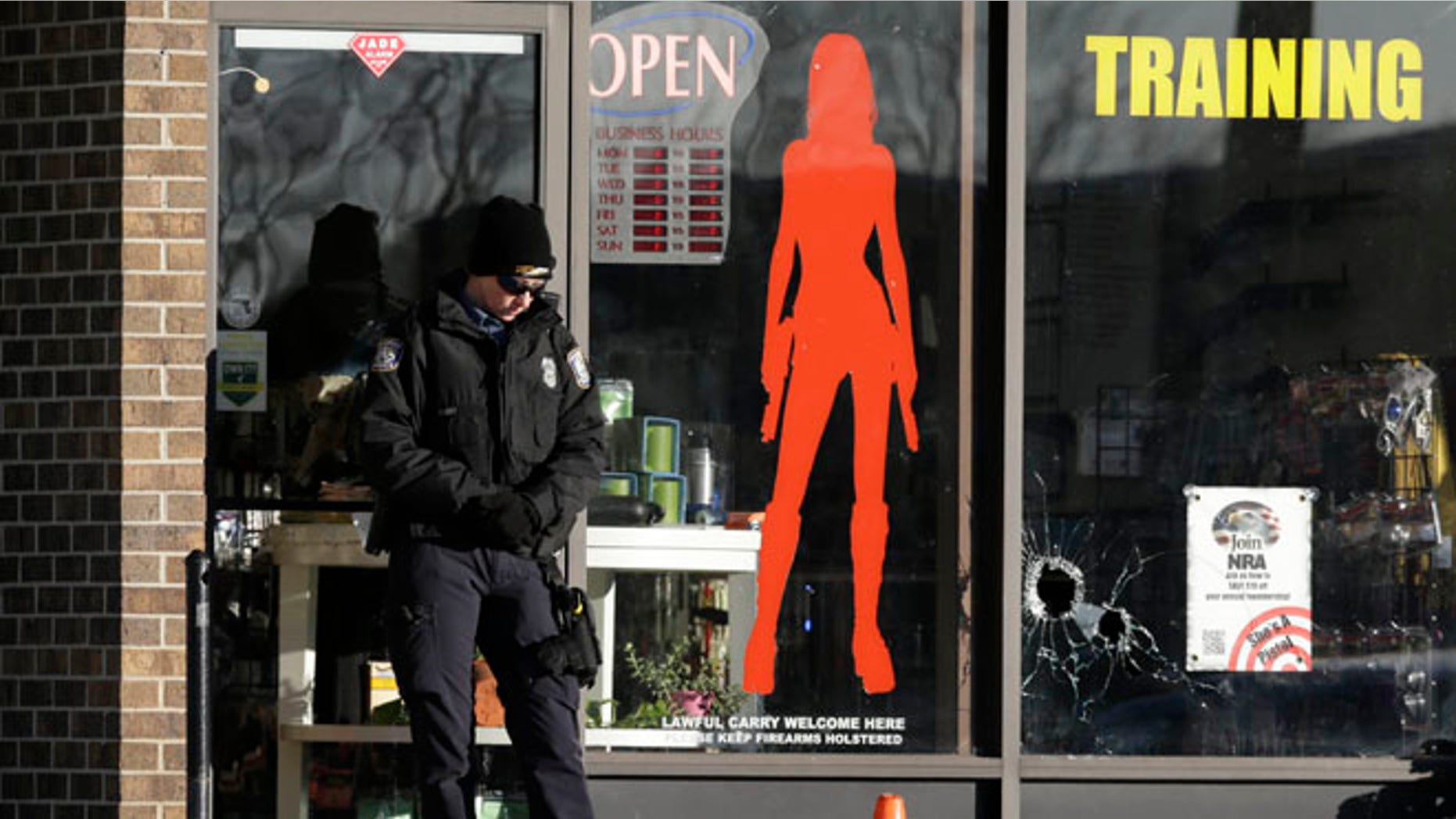 Jan. 9, 2015: A Law enforcement officer guards the scene of a shooting at She's a Pistol, LLC, a gun shop in Shawnee, Kan. (AP)