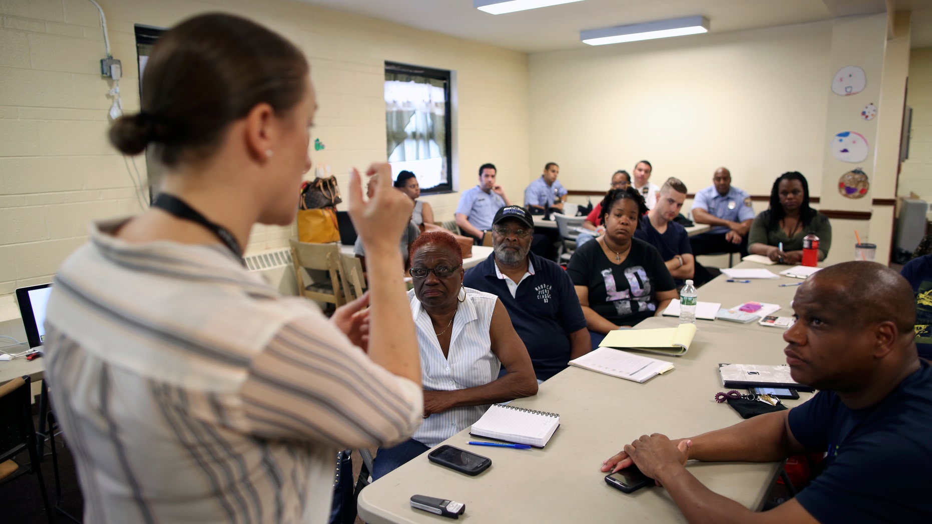In this Saturday, July 9, 2016 photo, Dr. Zoe Maher, a Temple trauma surgeon, explains the Philadelphia Immediate Transport in Penetrating Trauma Trial (PIPT) to community leaders, at the Hunting Park Community Center, in Philadelphia. The difference between being a gunshot survivor or a homicide victim may be what happens in the ambulance. Several Philadelphia hospitals are coming together for a study that will ask: When gunshot victims are rushed to the emergency room, could paramedics do more to save them by doing less? (AP Photo/ Joseph Kaczmarek)