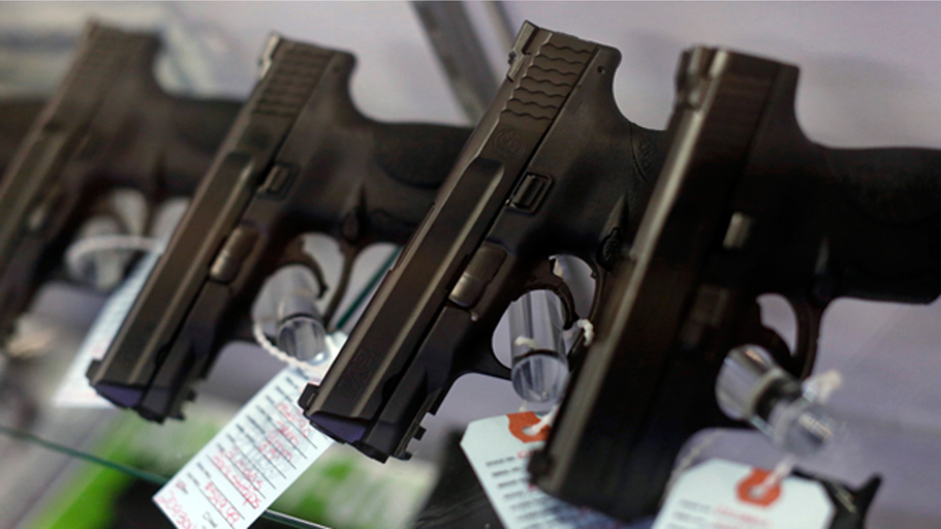 Nov. 13, 2014: Handguns are seen for sale in a display case at a gun store in Bridgeton, Mo.
