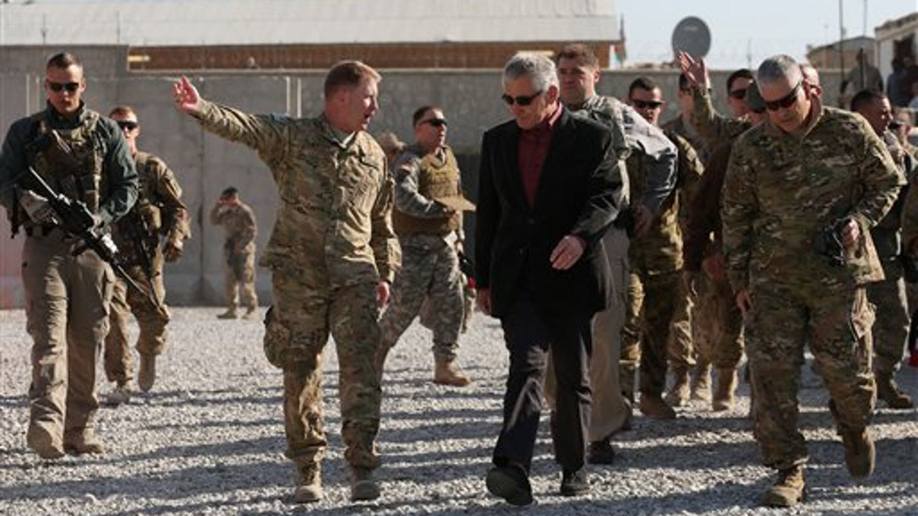 Dec. 7, 2014: U.S. Secretary of Defense Chuck Hagel, center, is escorted by U.S. Army Brigadier General Christopher F. Bentley, center left, after his arrival at Tactical Base Gamberi in eastern Afghanistan.